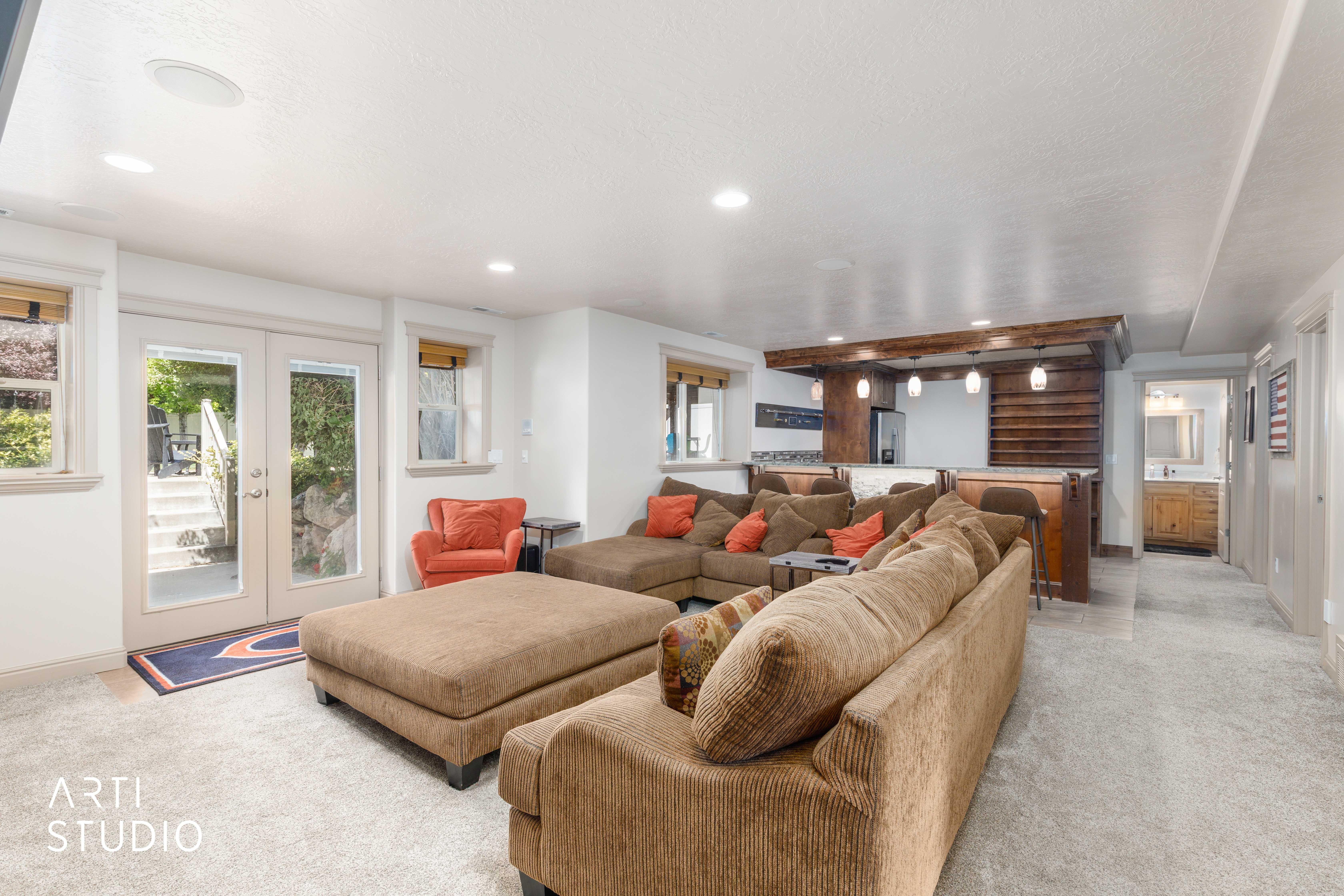 Lower level family room with wet bar and french doors to the backyard