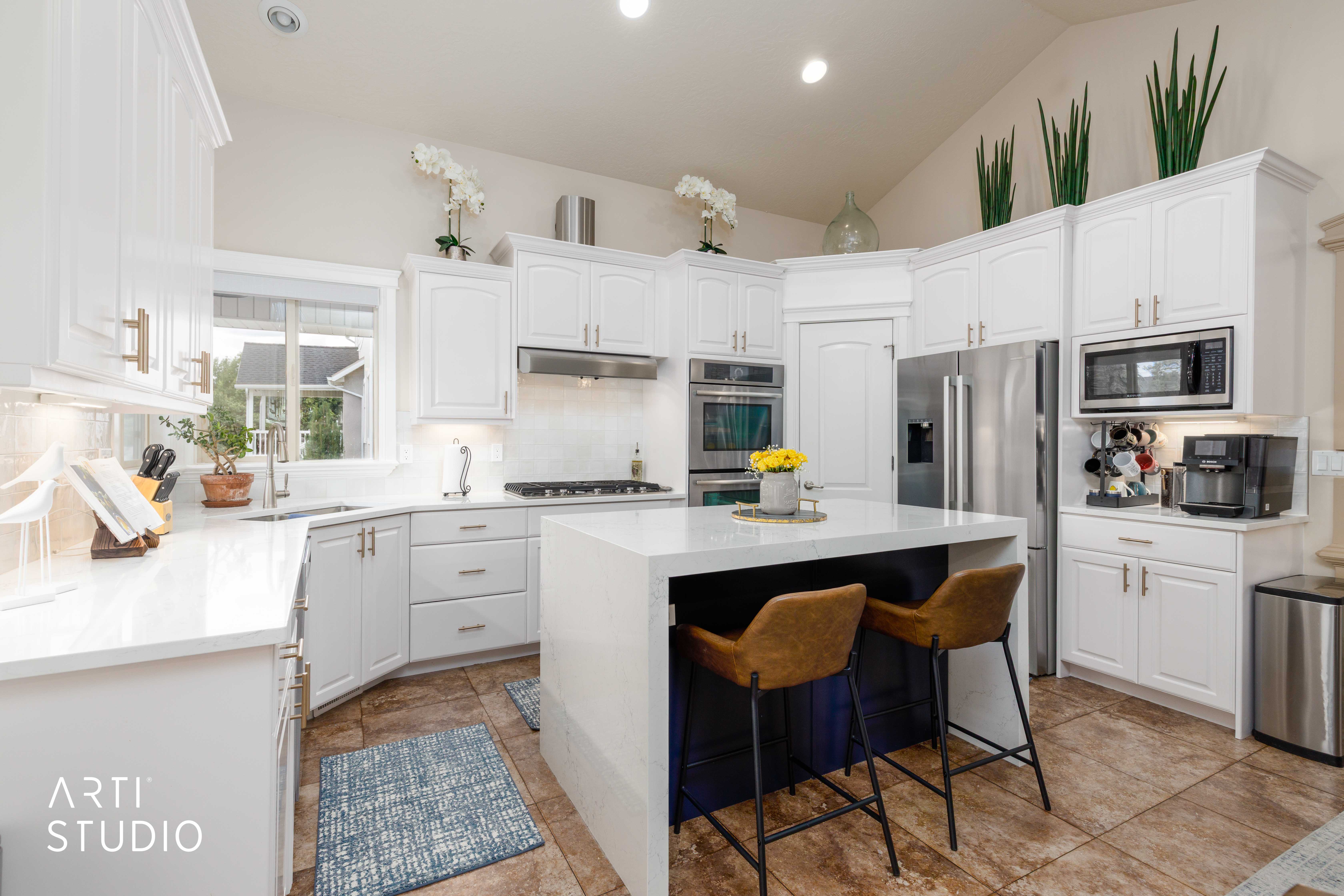 Gourmet kitchen with center island featuring quartz waterfall counter top