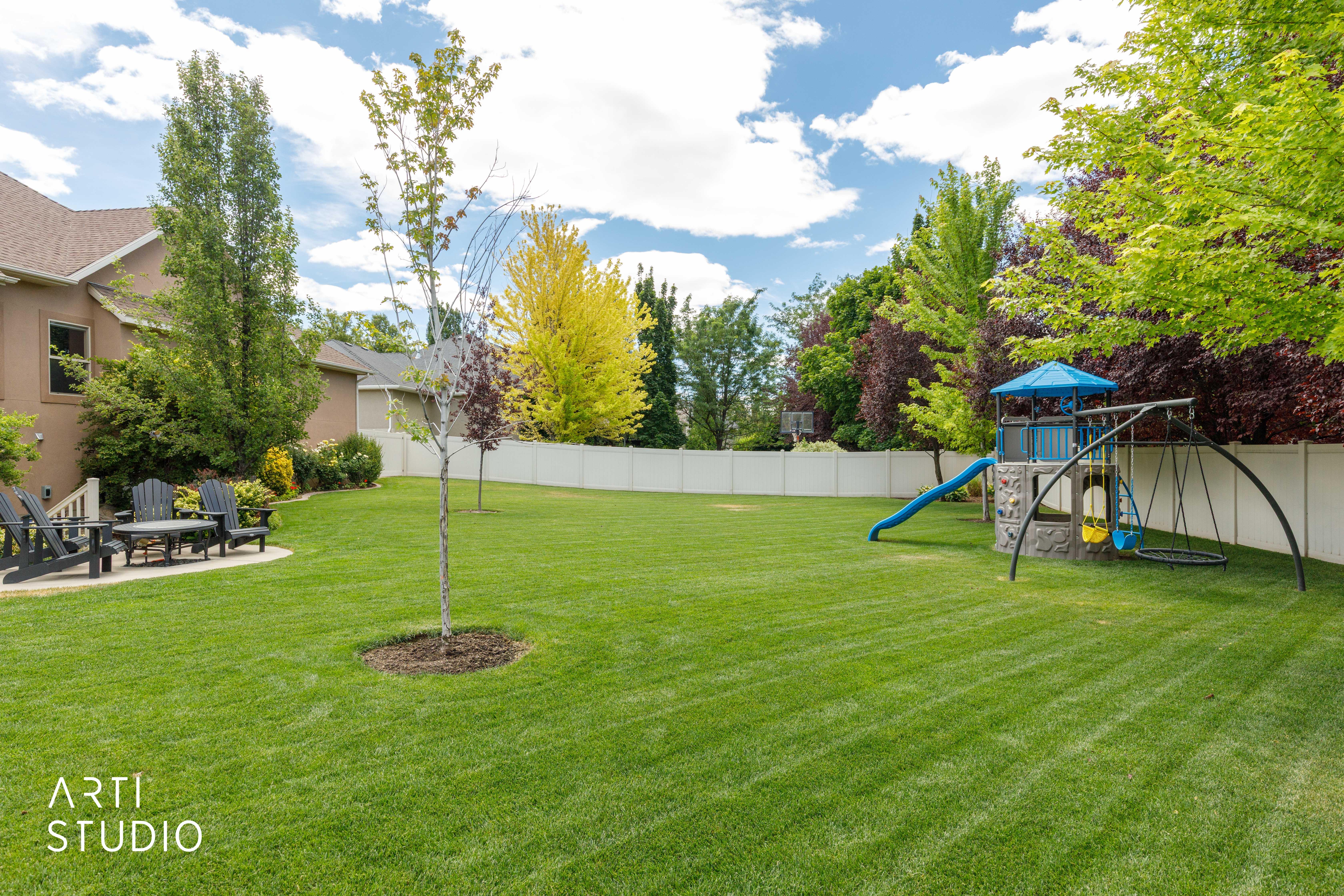Fenced back yard with mature landscaping