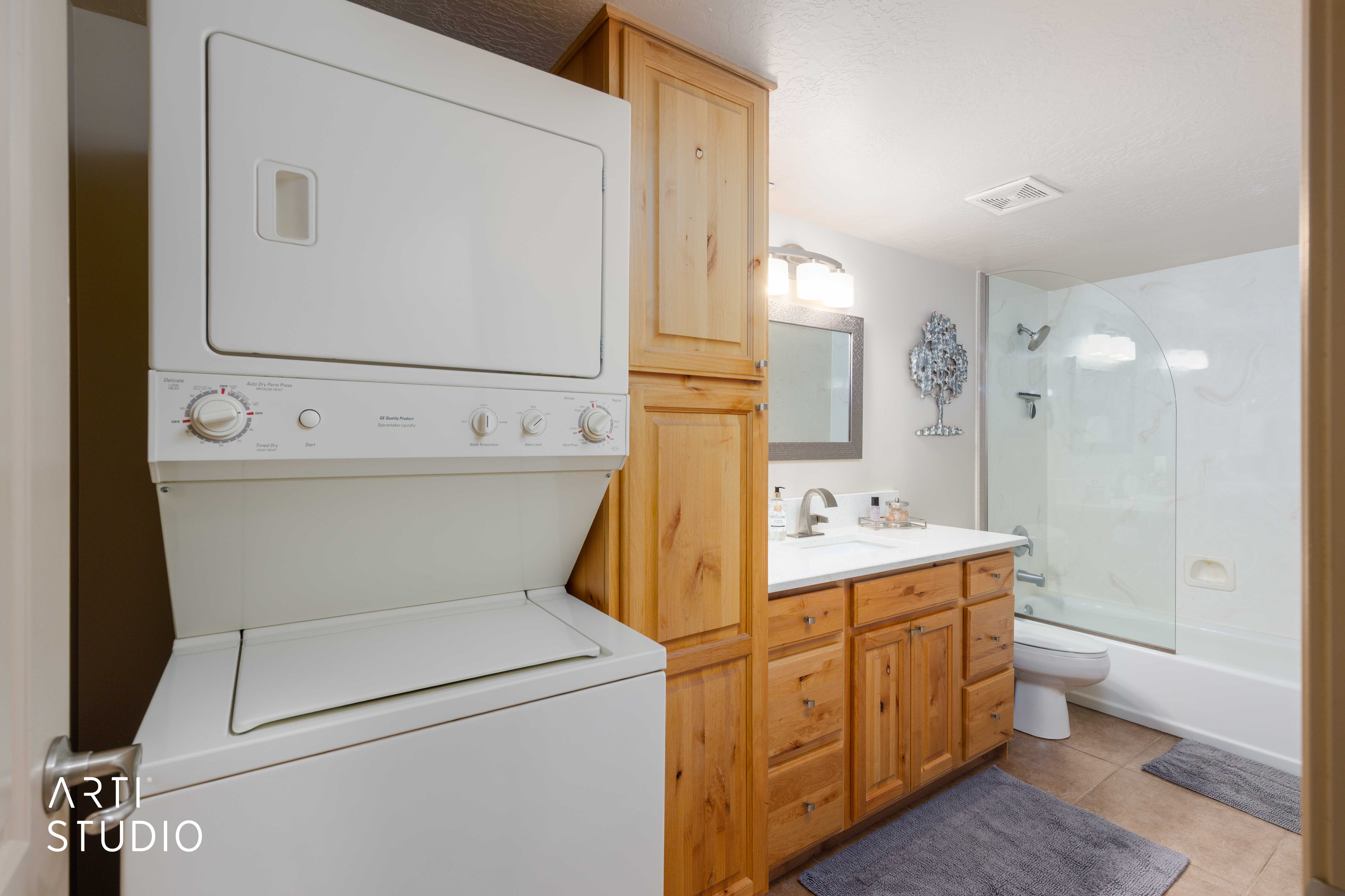 Second lower level bathroom with stackable laundry