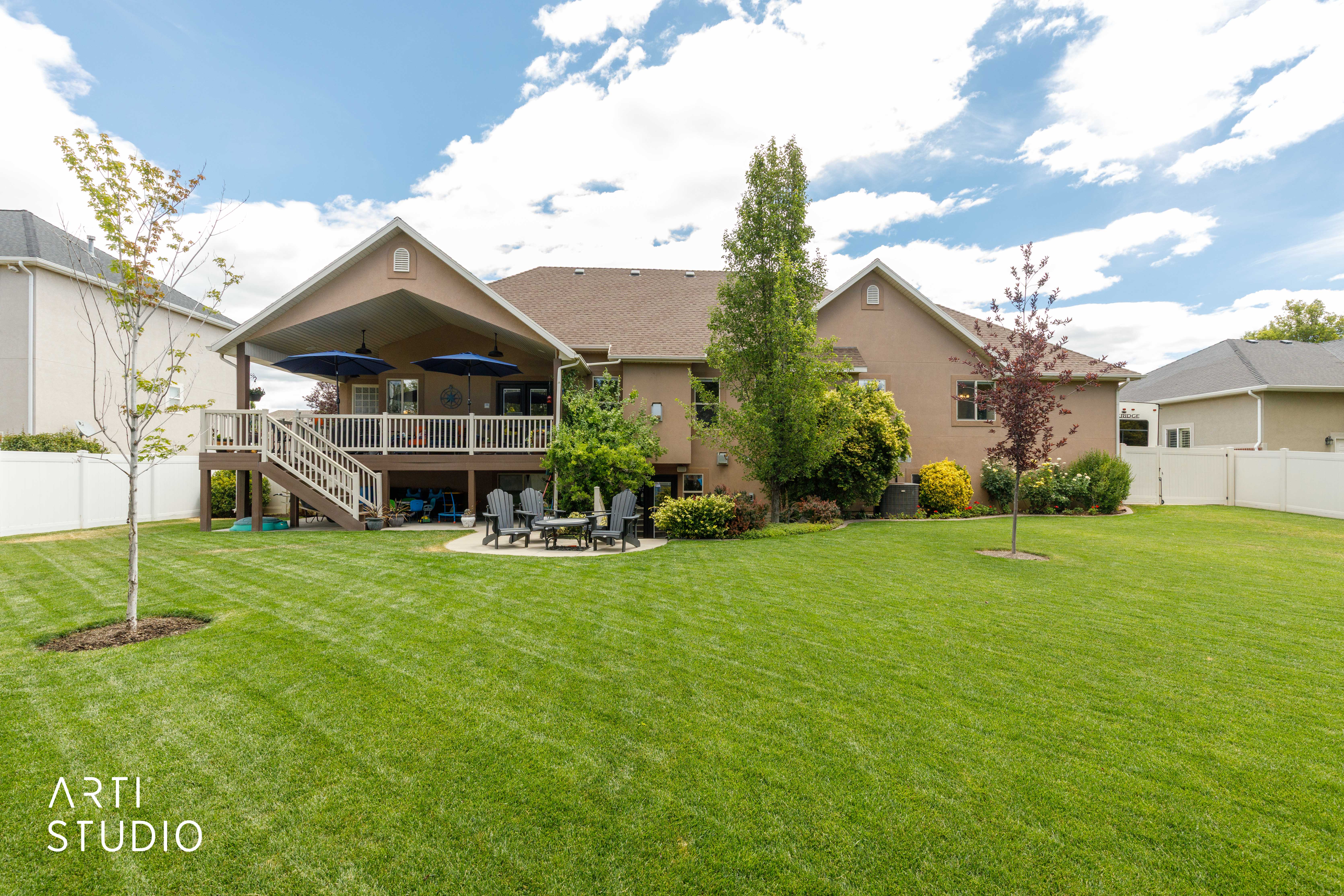 landscaped yard with spacious covered deck and lower level walk-out