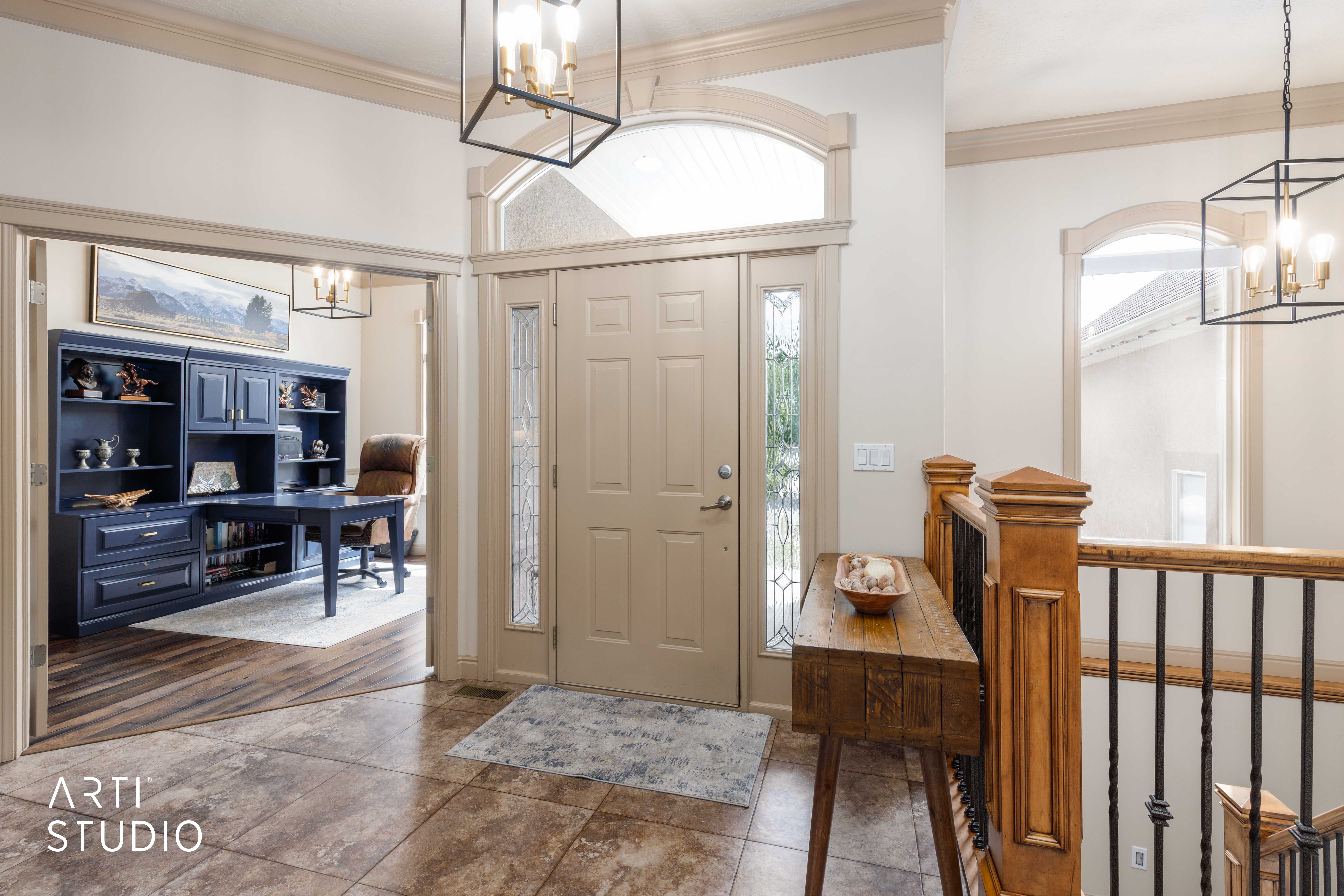 Entry foyer featuring decorative sidelights and an arched transom window