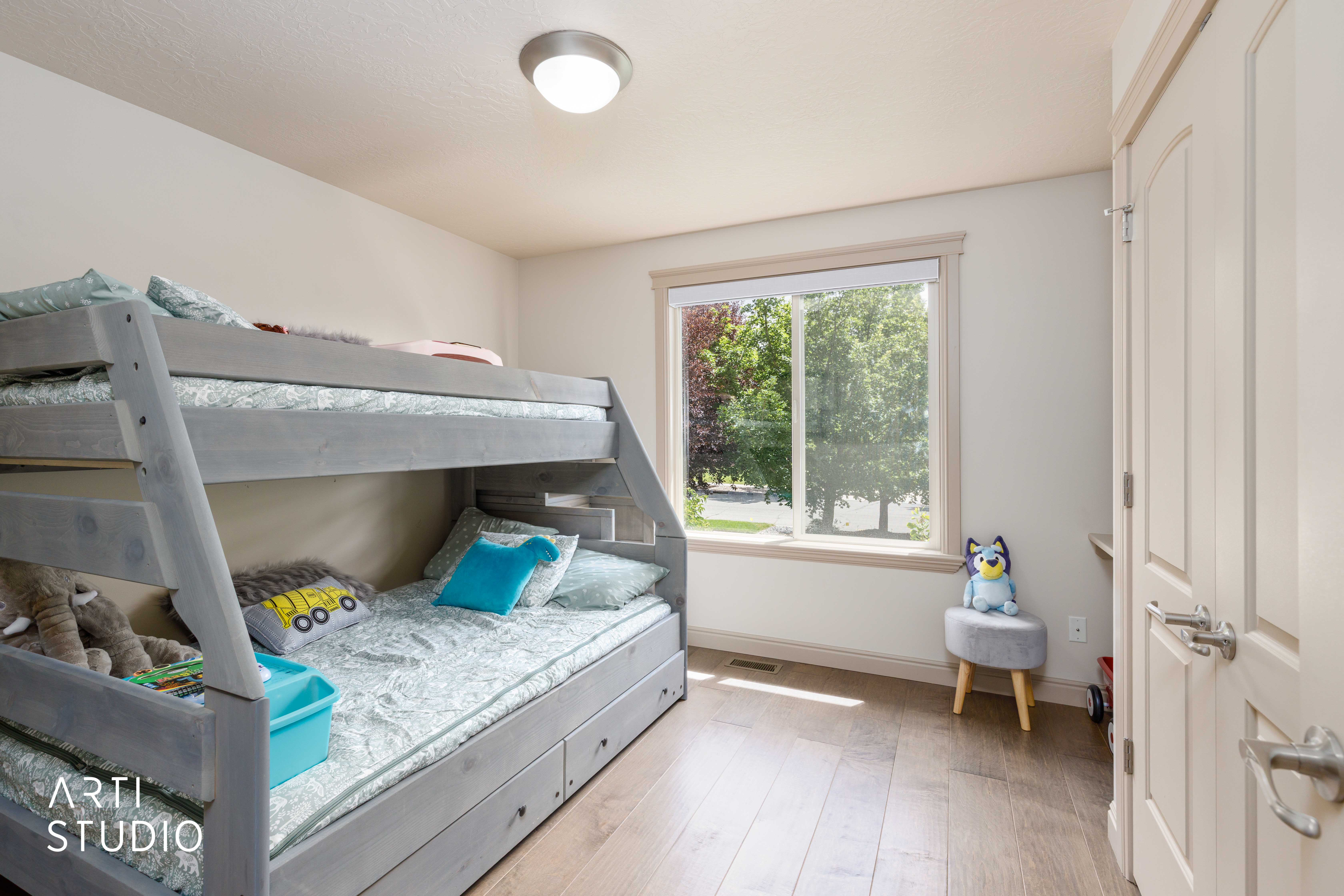 Second main level bedroom with wood flooring and double closet