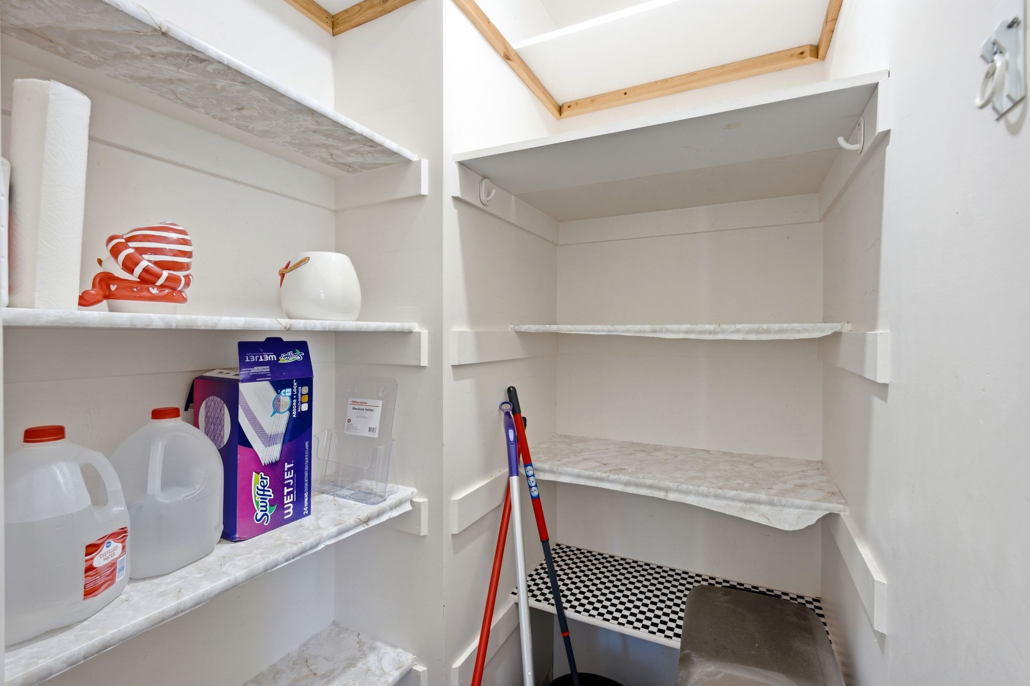 Built-in shelving with white-painted wood construction and patterned shelf liners