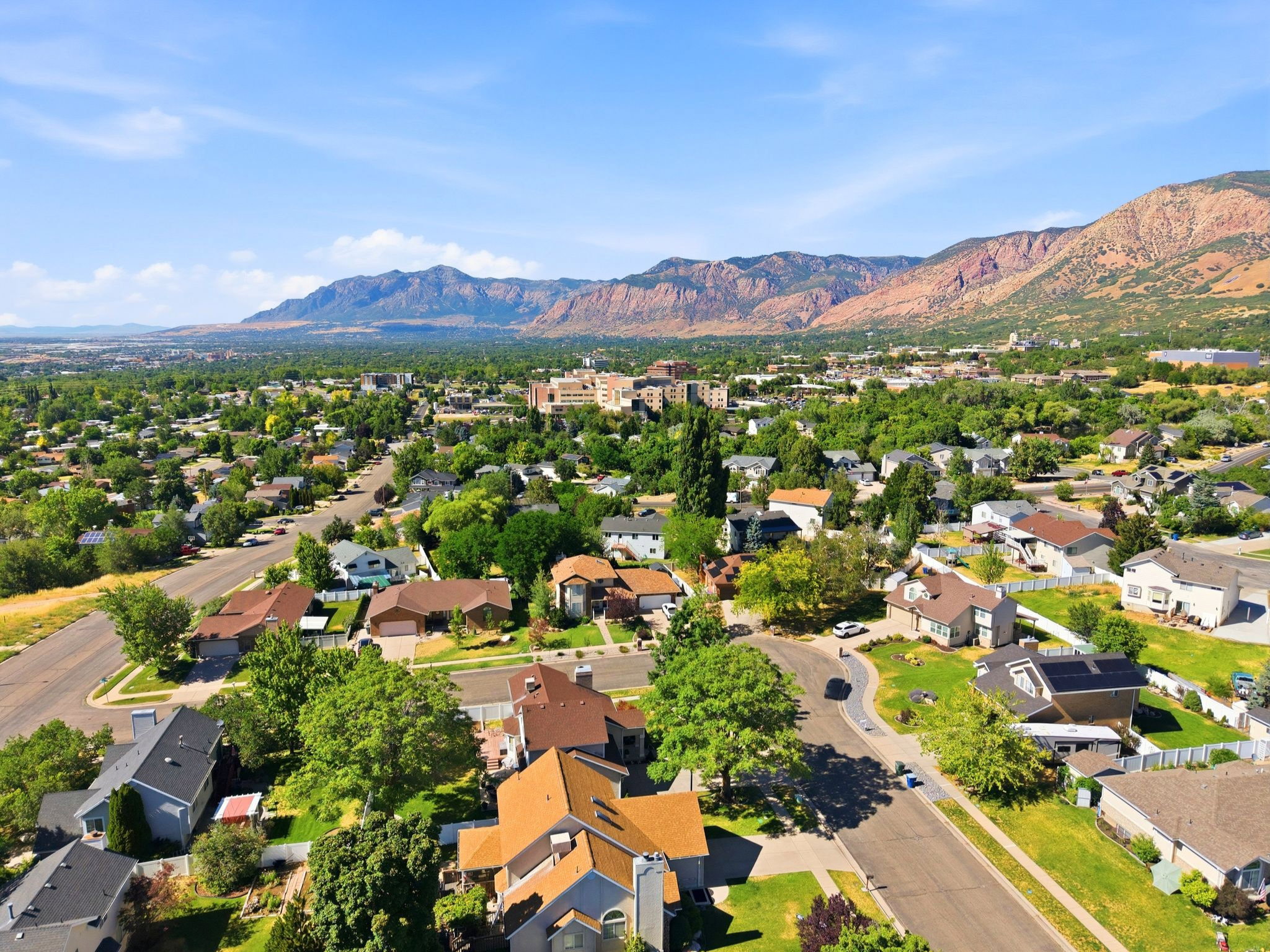 Expansive residential area featuring numerous single-family homes with diverse architectural styles, mature trees, and paved streets