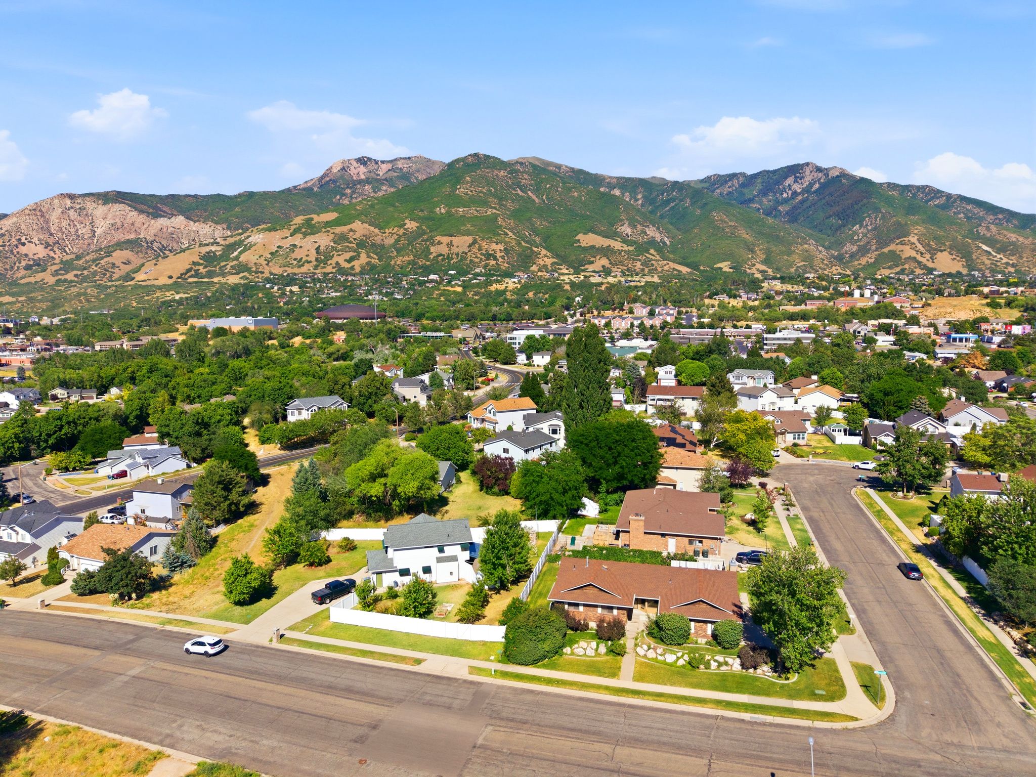 Aerial perspective of a residential neighborhood with prominent mountain backdrop