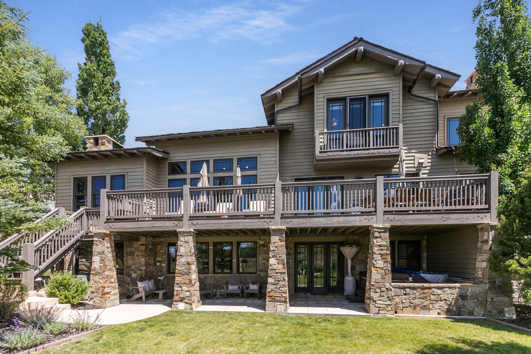 Multi-level property featuring extensive decking and stone accents