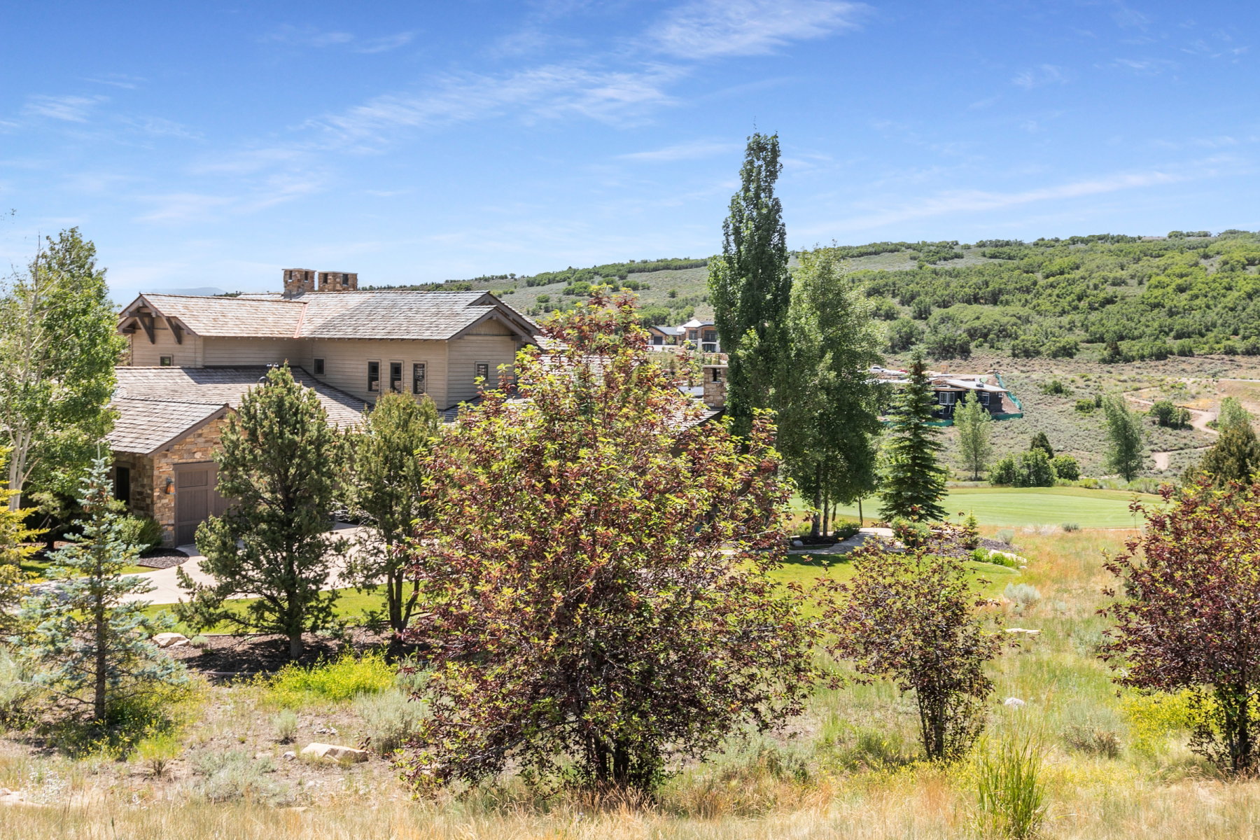 Stone and stucco exterior with multiple gables and a multi-level roofline