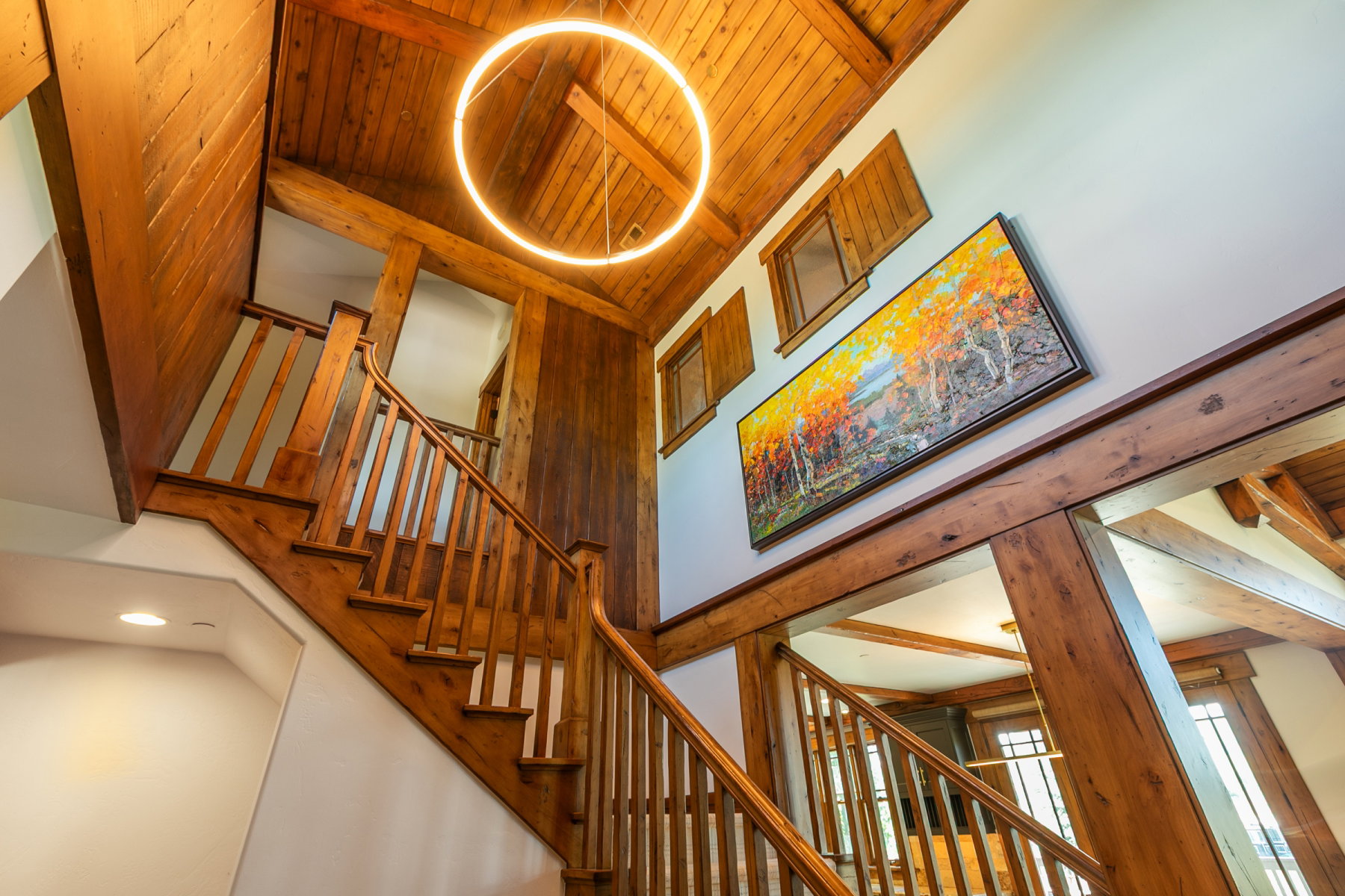 Grand wooden staircase with matching wood railing and balusters