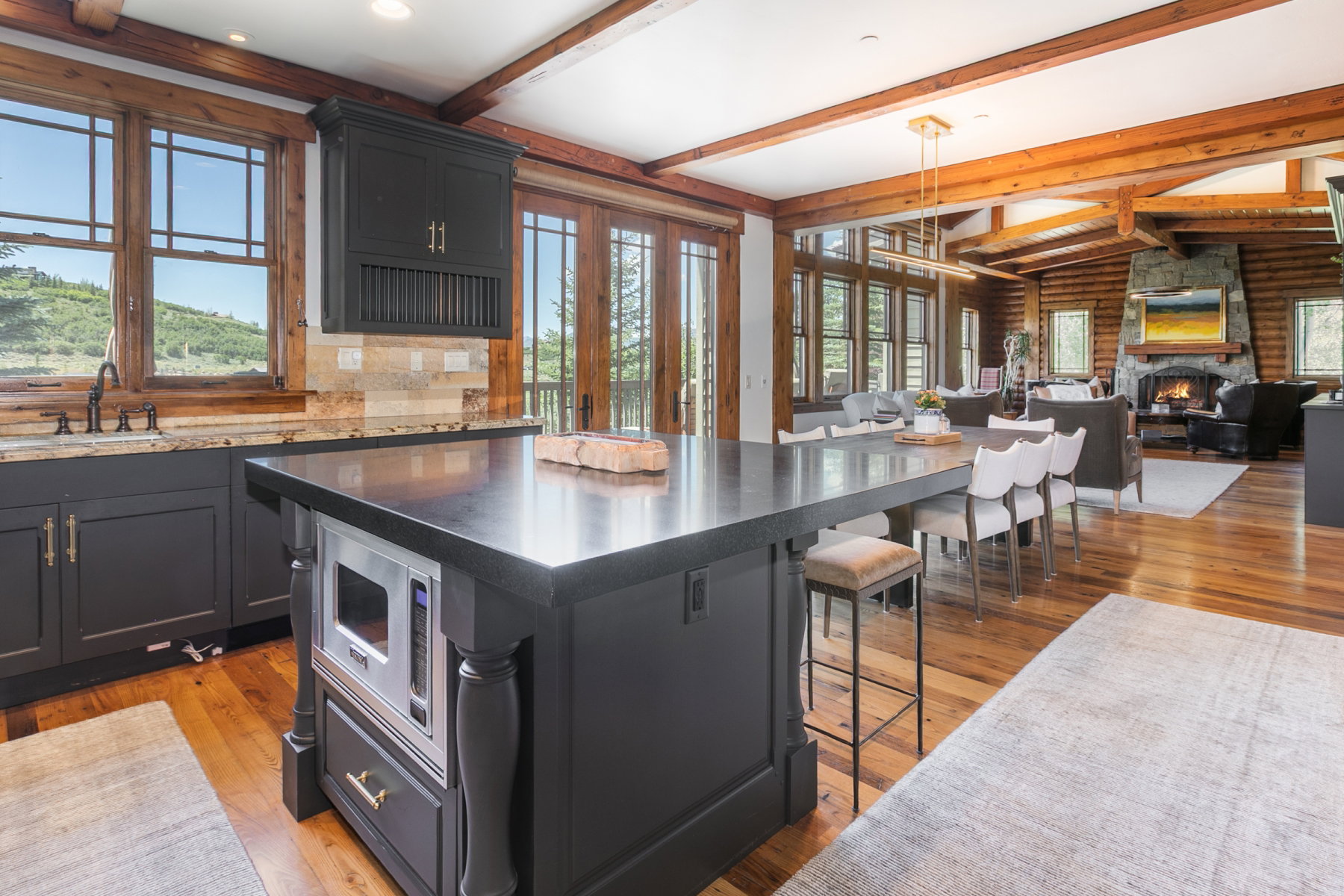 Kitchen island featuring a dark countertop and integrated microwave drawer