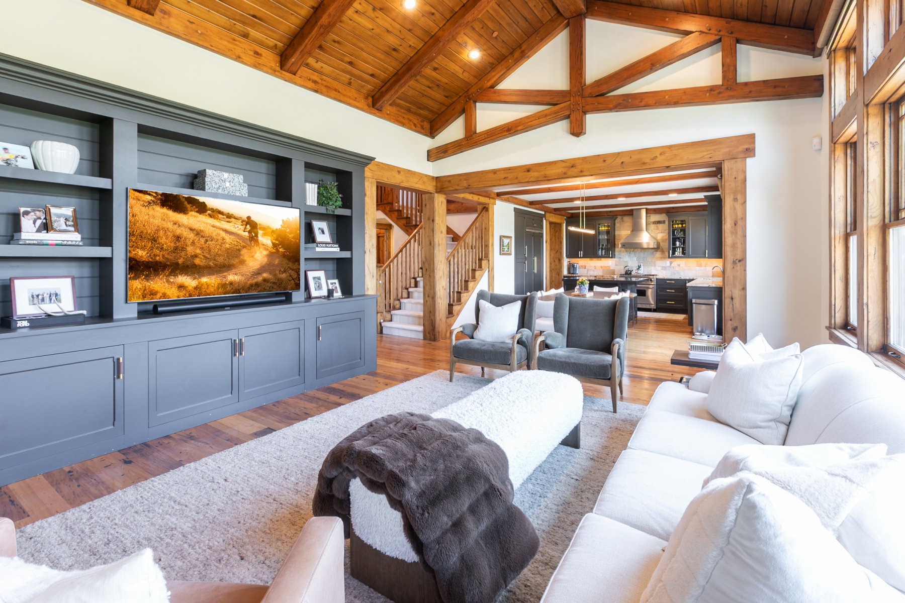 Vaulted wood-beamed ceilings create an expansive atmosphere