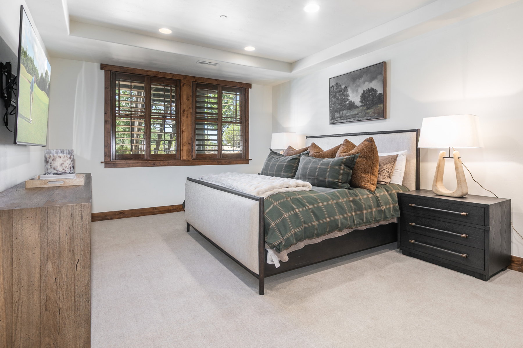 Carpeted bedroom featuring recessed lighting, a window with wood plantation shutters, and light-colored walls