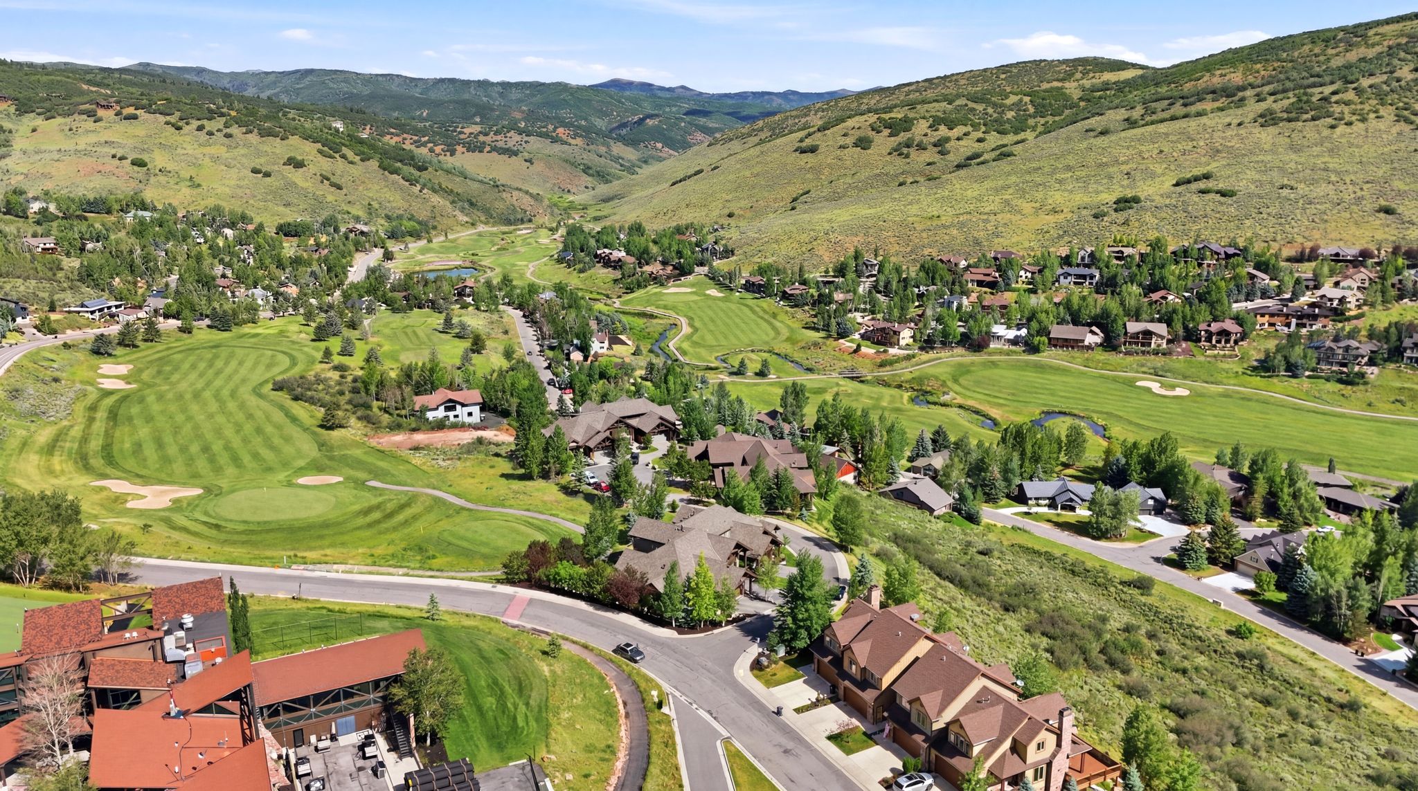 Expansive aerial perspective showcasing a mountainous valley setting