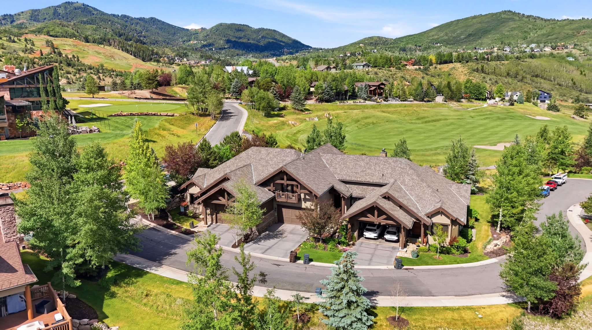 Expansive property featuring a multi-gabled roofline and a stone and wood exterior