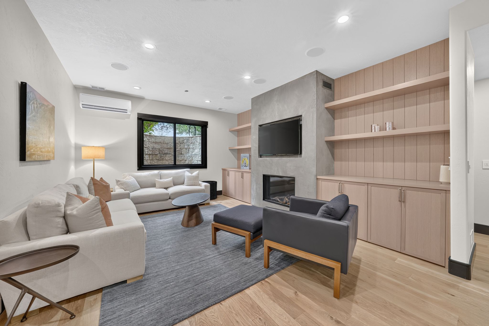 Living space featuring light wood-finish flooring and recessed lighting