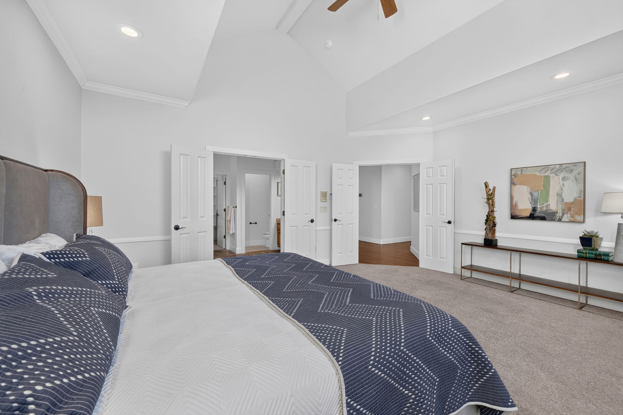 Vaulted ceilings with recessed lighting and a ceiling fan