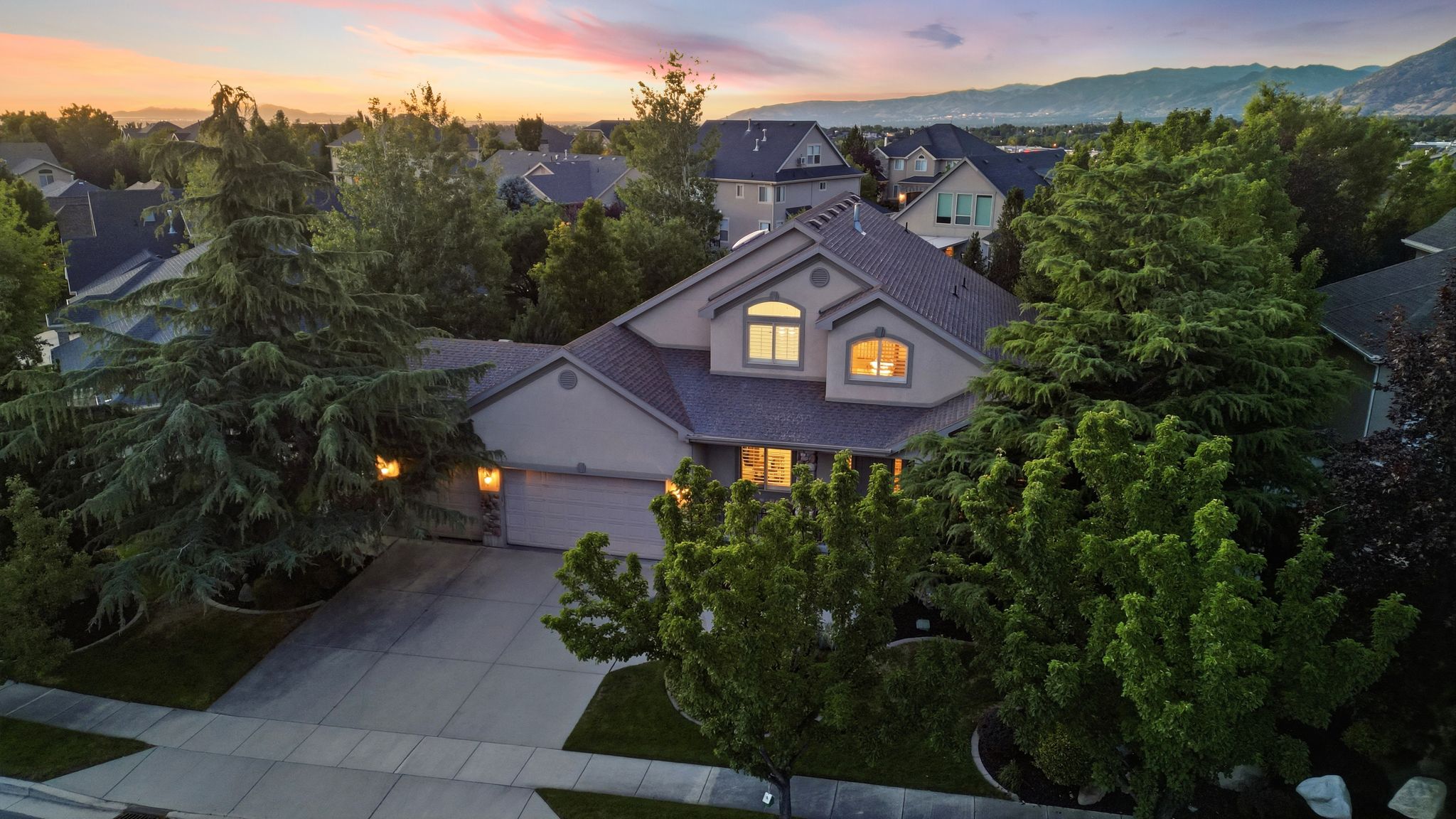 Single-family residence featuring a two-car garage and a paved driveway