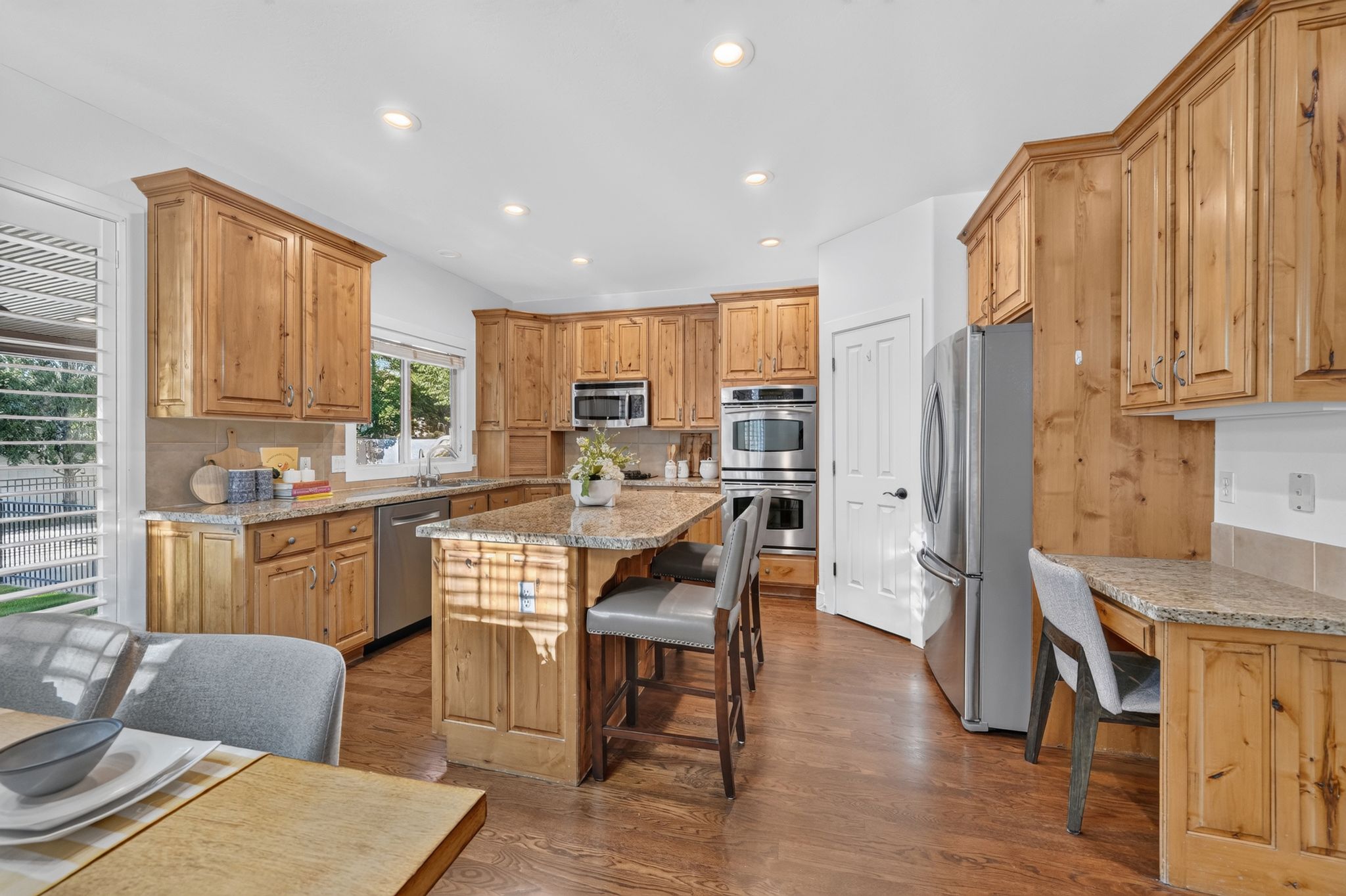 Spacious kitchen featuring natural wood cabinetry and a central island with bar seating