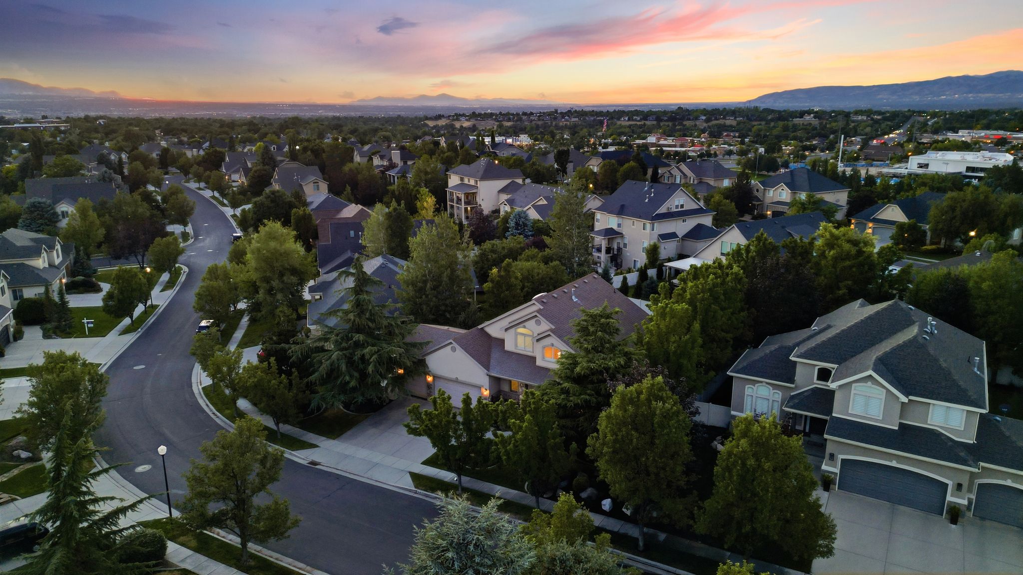 Residential neighborhood featuring mature trees and a winding street