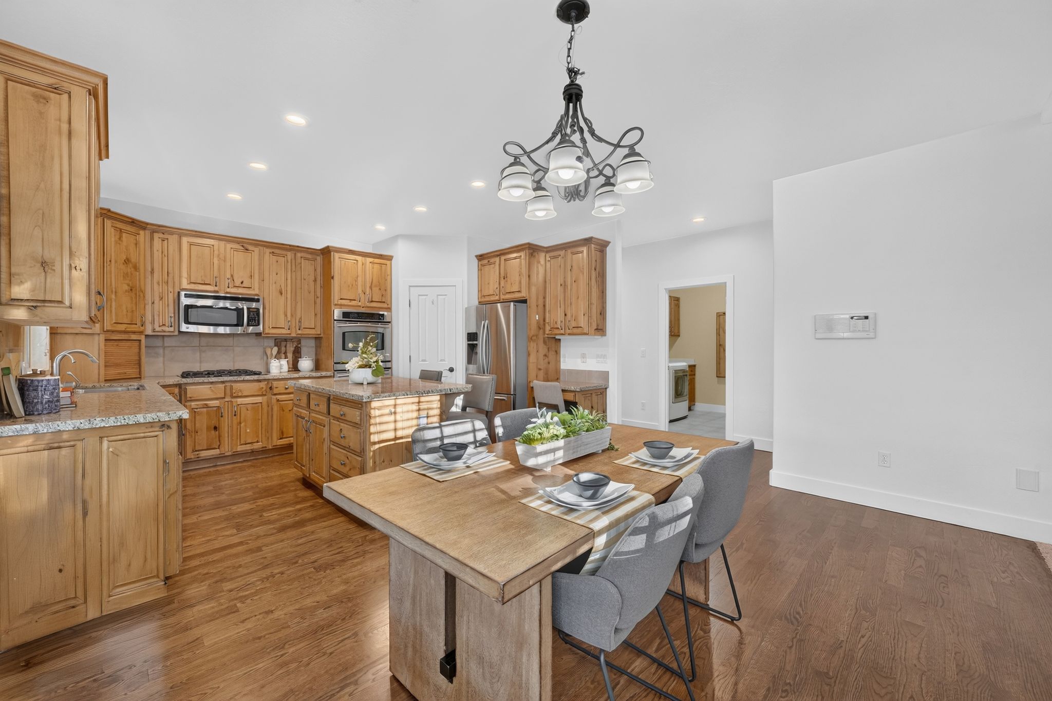 Kitchen and dining area featuring wood-finish flooring