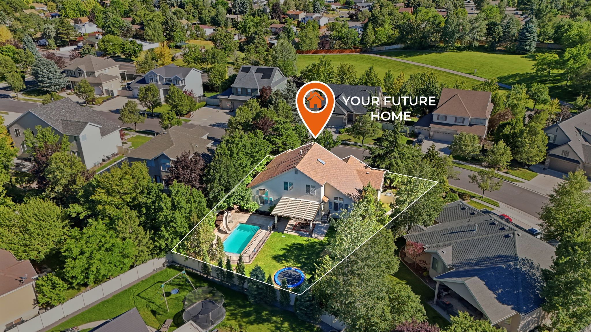 Expansive backyard featuring a fenced perimeter, inground swimming pool, manicured lawn, and mature trees