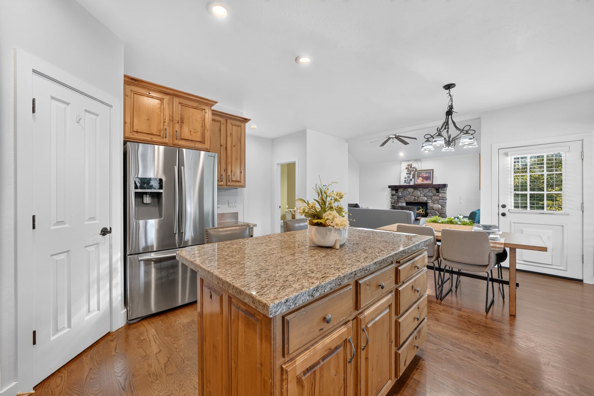 Kitchen island featuring a substantial countertop and rich wood-finish cabinetry