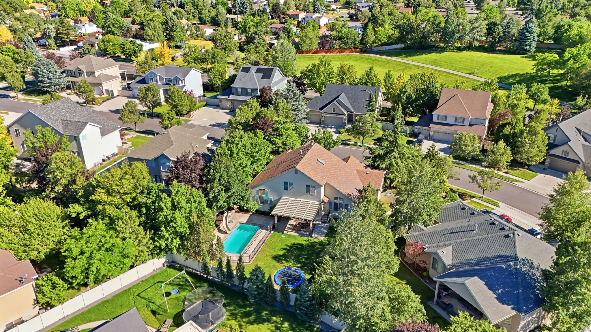 Aerial perspective showcasing a residential area with varied home styles and mature landscaping