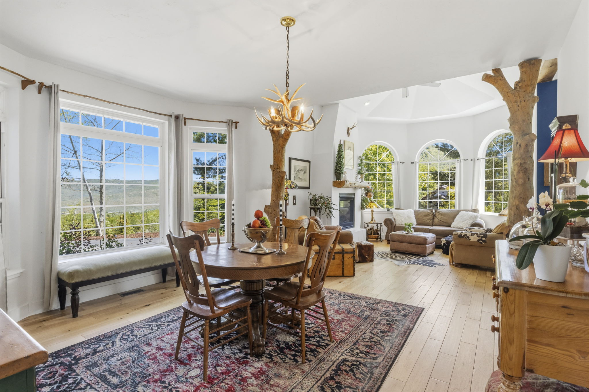 Spacious interior featuring light wood-finish flooring and a central antler chandelier