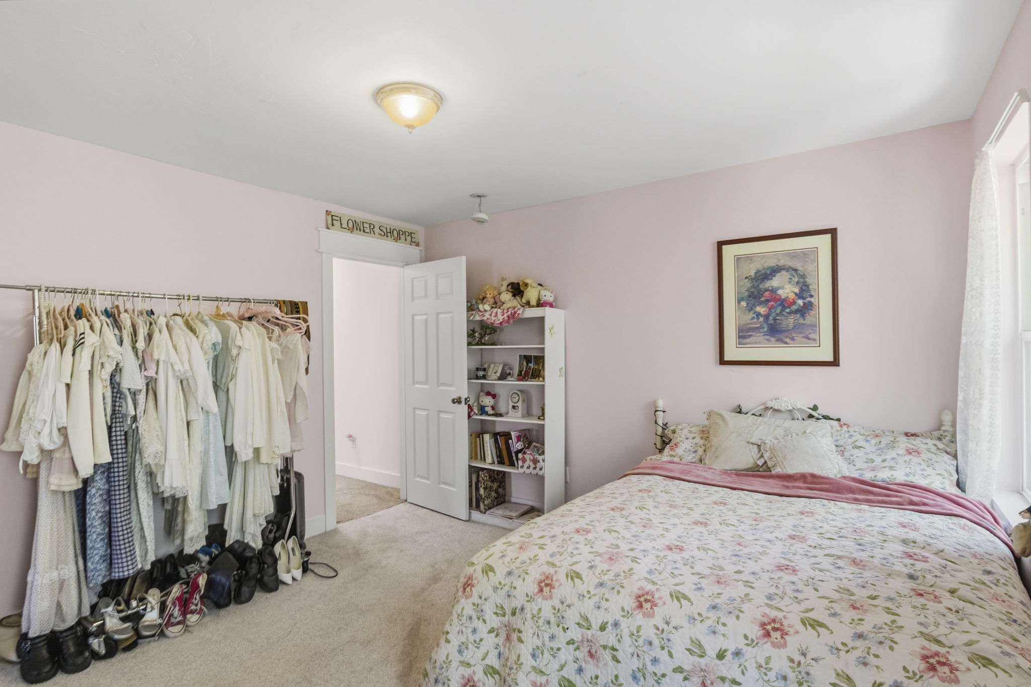 Carpeted interior space with a window offering natural light