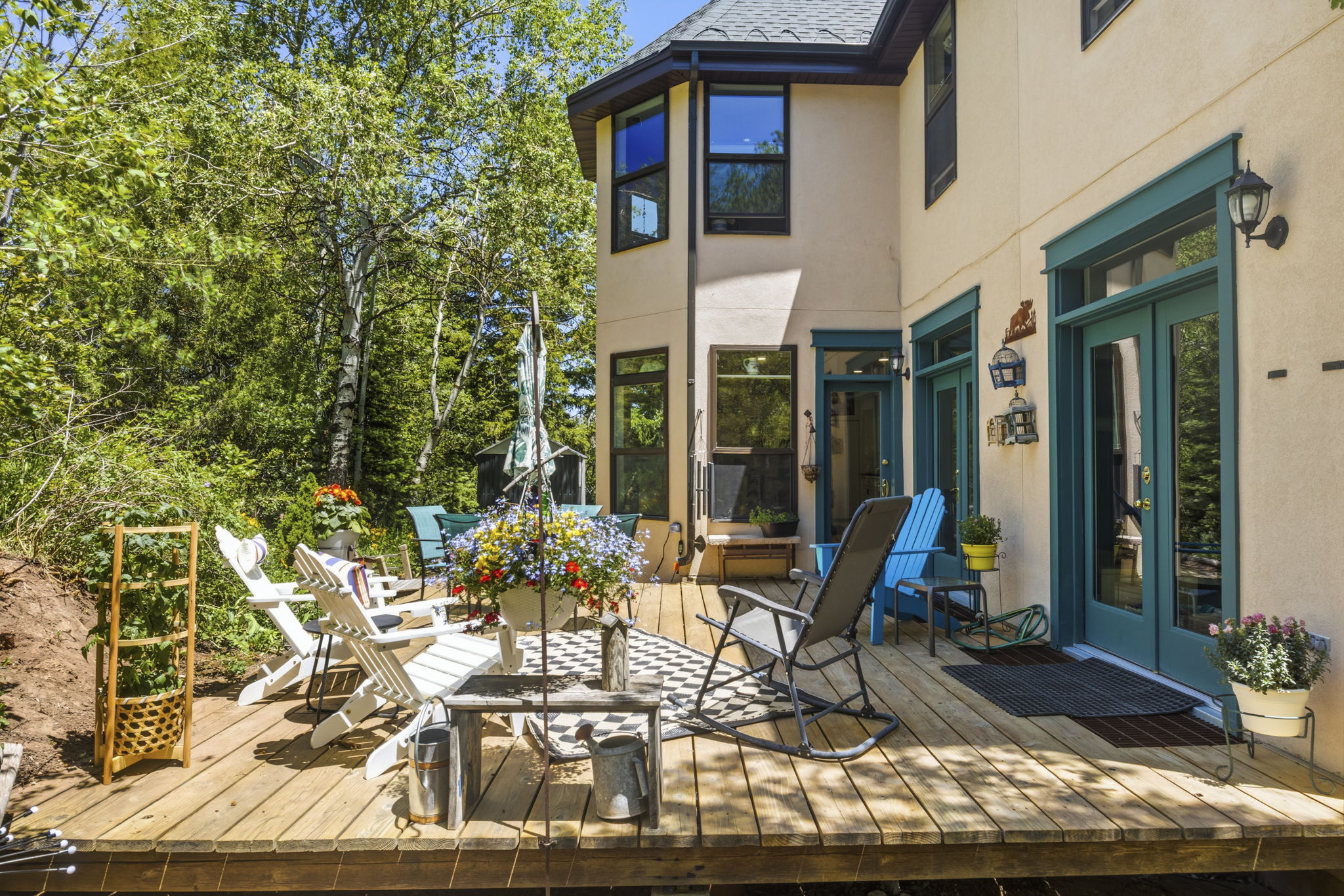 Expansive wood deck with multiple access points to the property