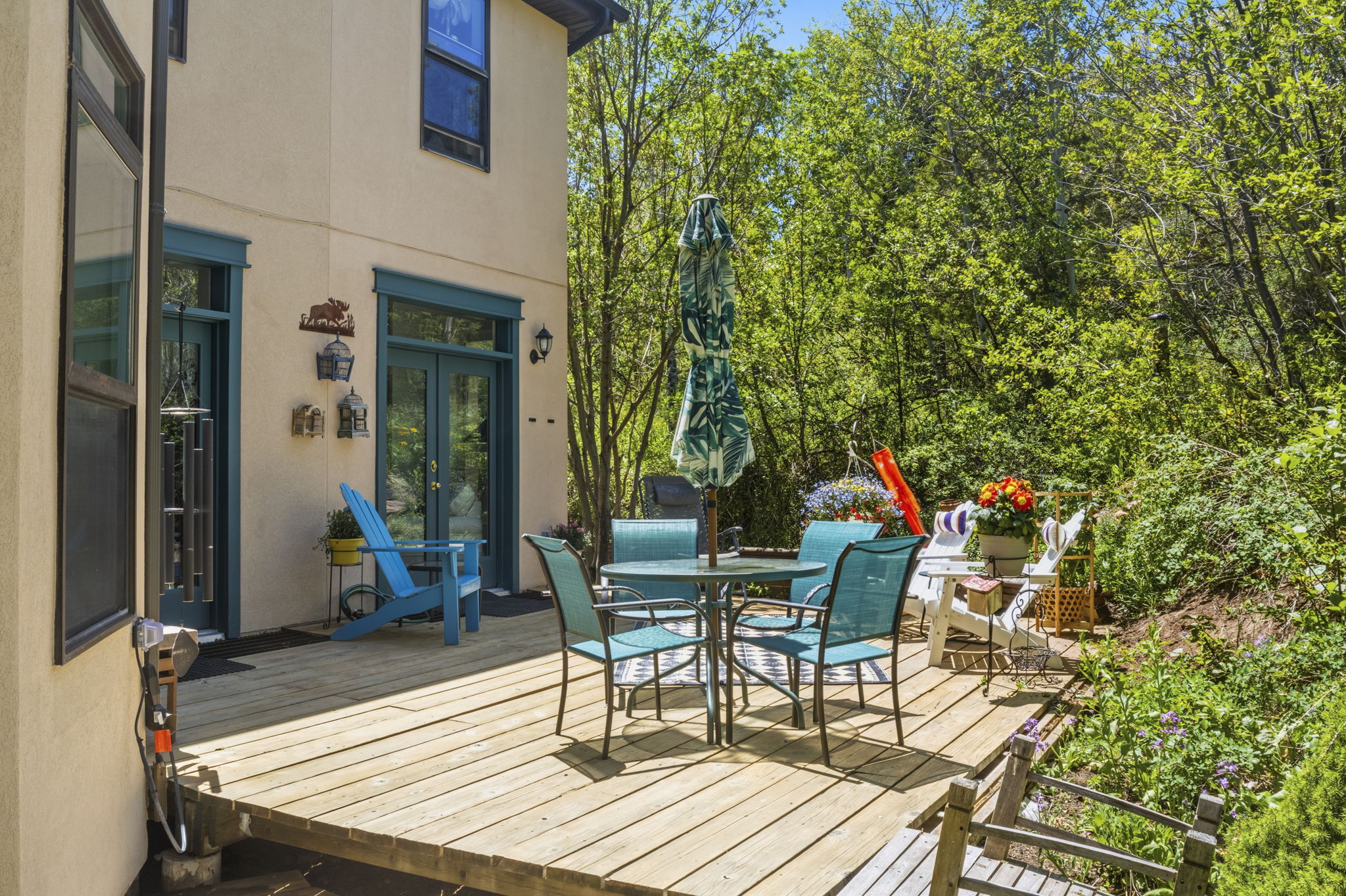 Expansive wooden deck featuring direct access to the home via double French doors