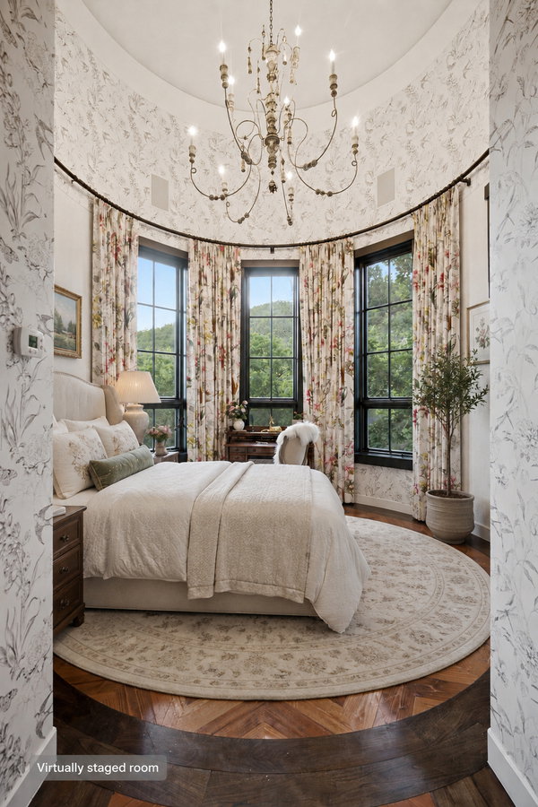 Curved room with patterned wall coverings and a decorative chandelier