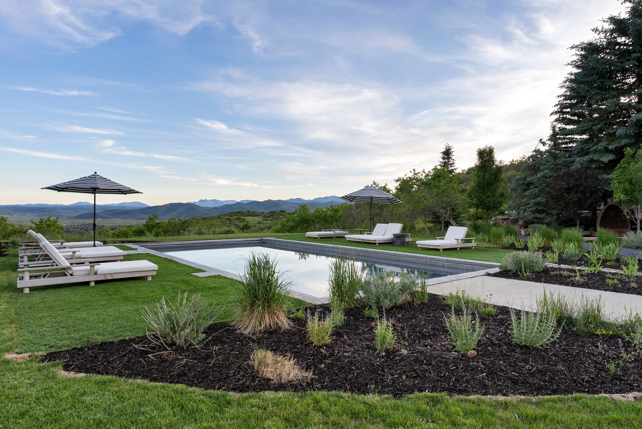 Rectangular inground swimming pool set within a manicured lawn