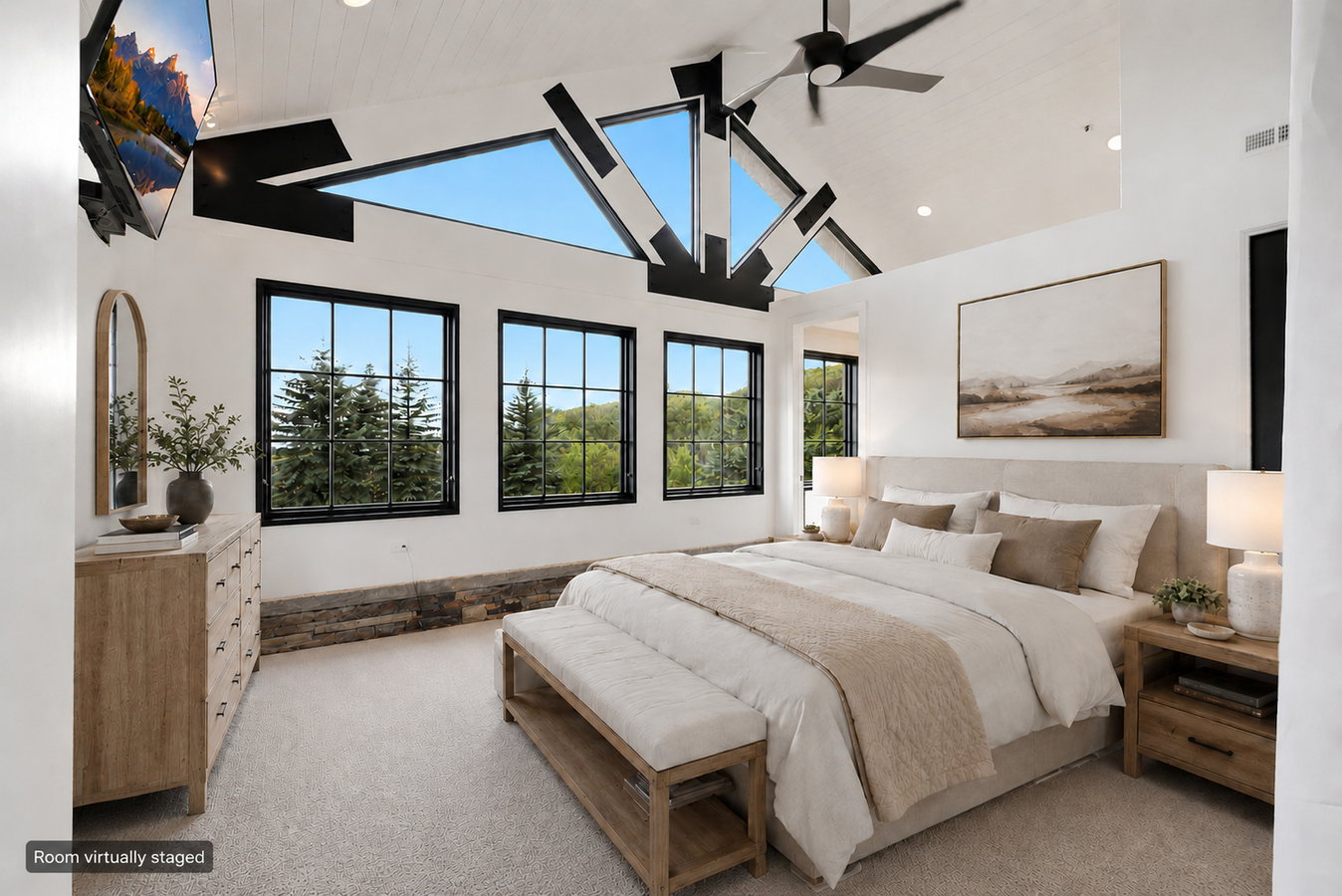 Vaulted ceiling room with exposed black structural beams