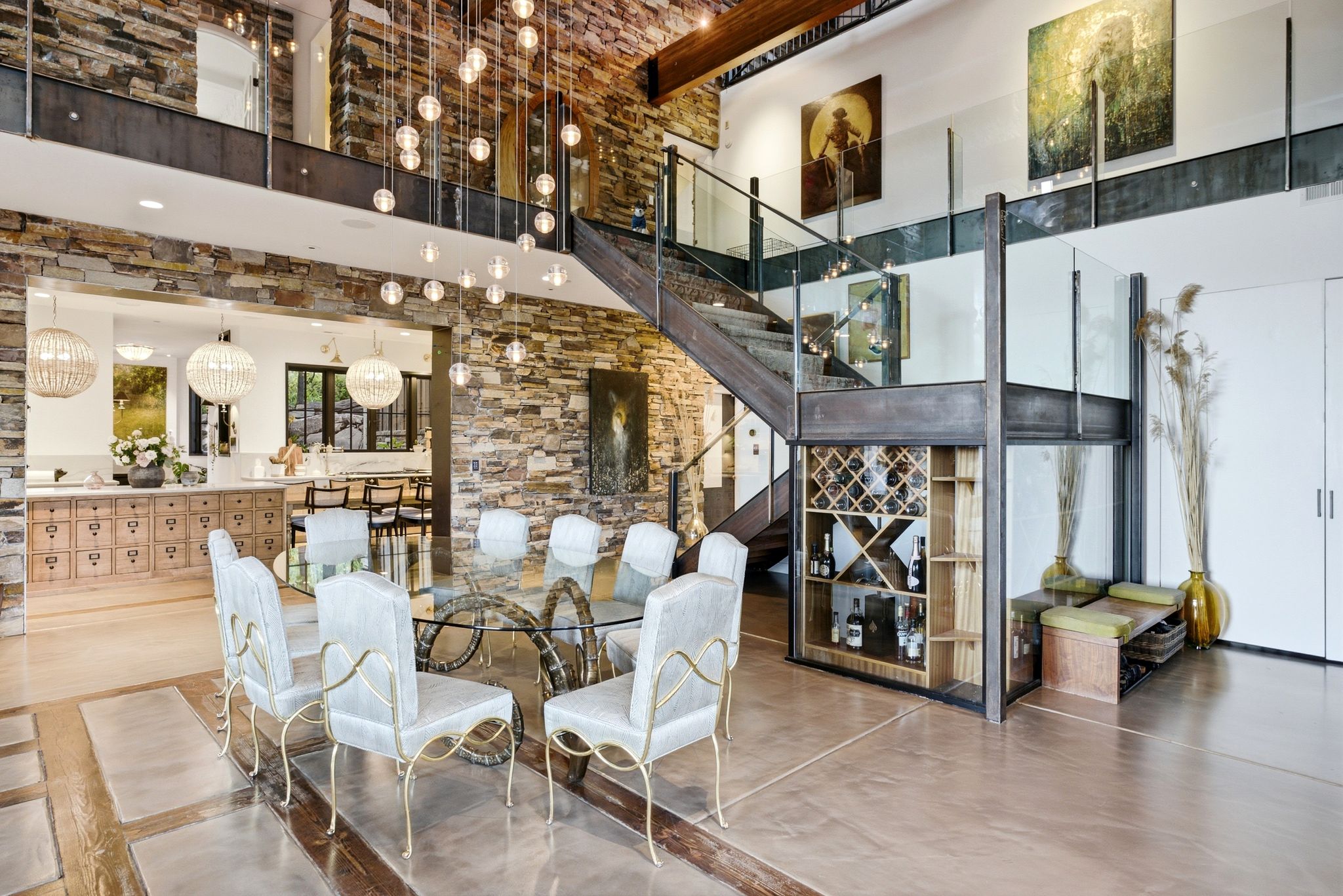 Open-concept living space with multi-level design featuring a stone accent wall