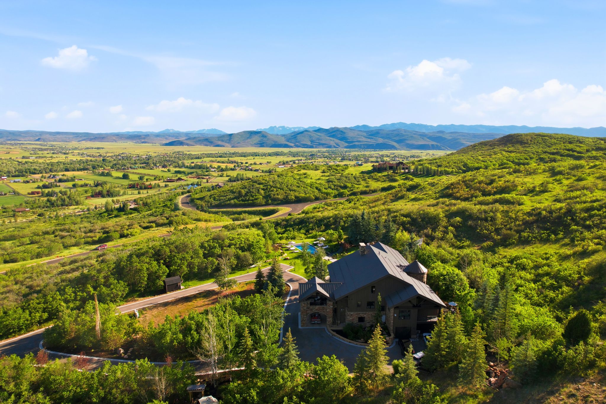 Mountain property featuring a stone and wood exterior with a multi-gabled roofline