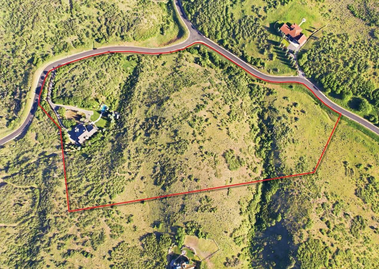 Expansive land parcel with defined boundaries and surrounding paved roads