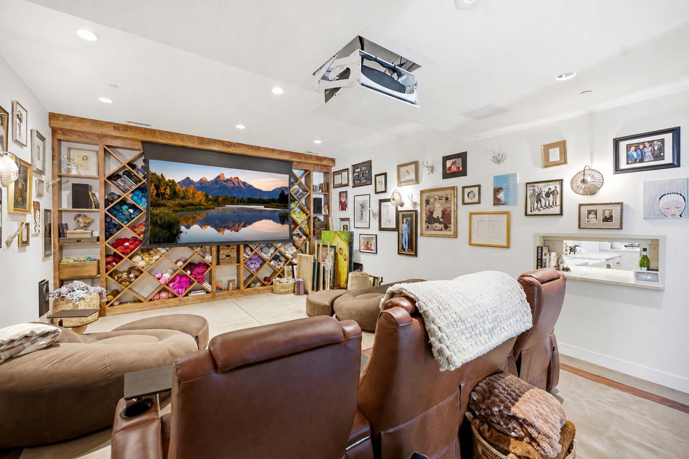 Dedicated media room featuring a large projection screen and ceiling-mounted projector