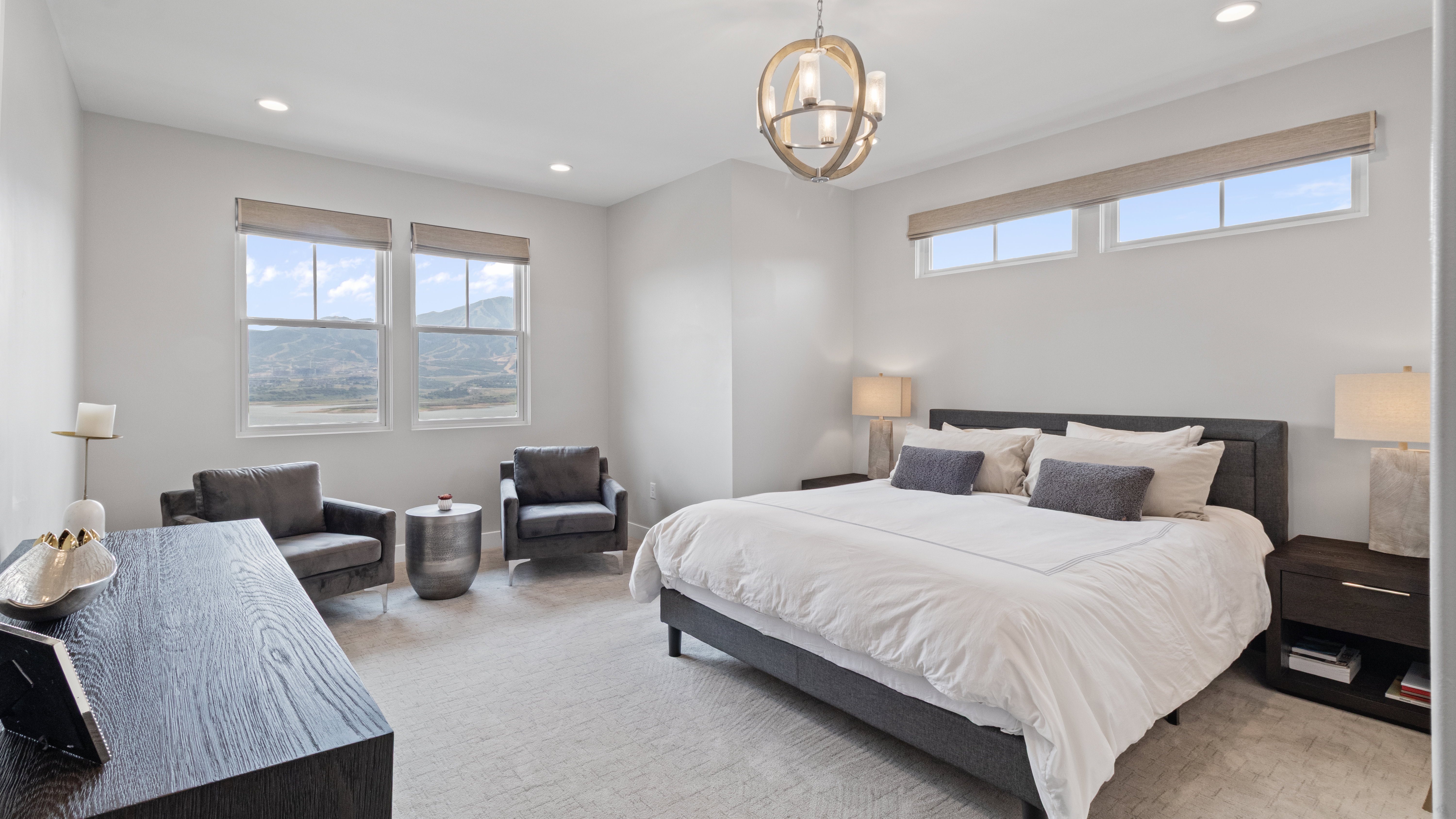 Spacious Primary Suite featuring carpeting, high ceilings with recessed lighting, and a contemporary chandelier
