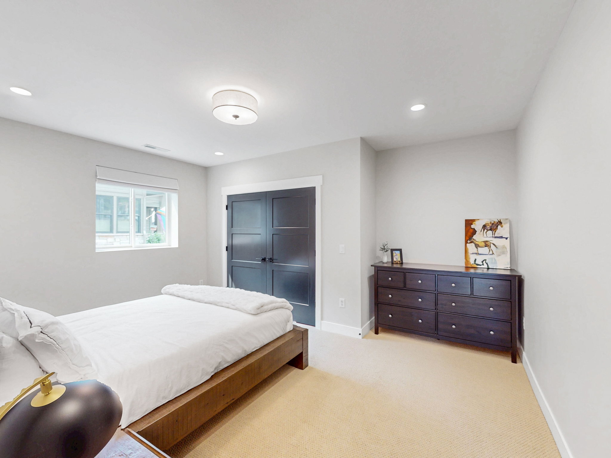 Bedroom #4 features bright interior space, a window with white trim, recessed lighting, and a semi-flush mount ceiling fixture