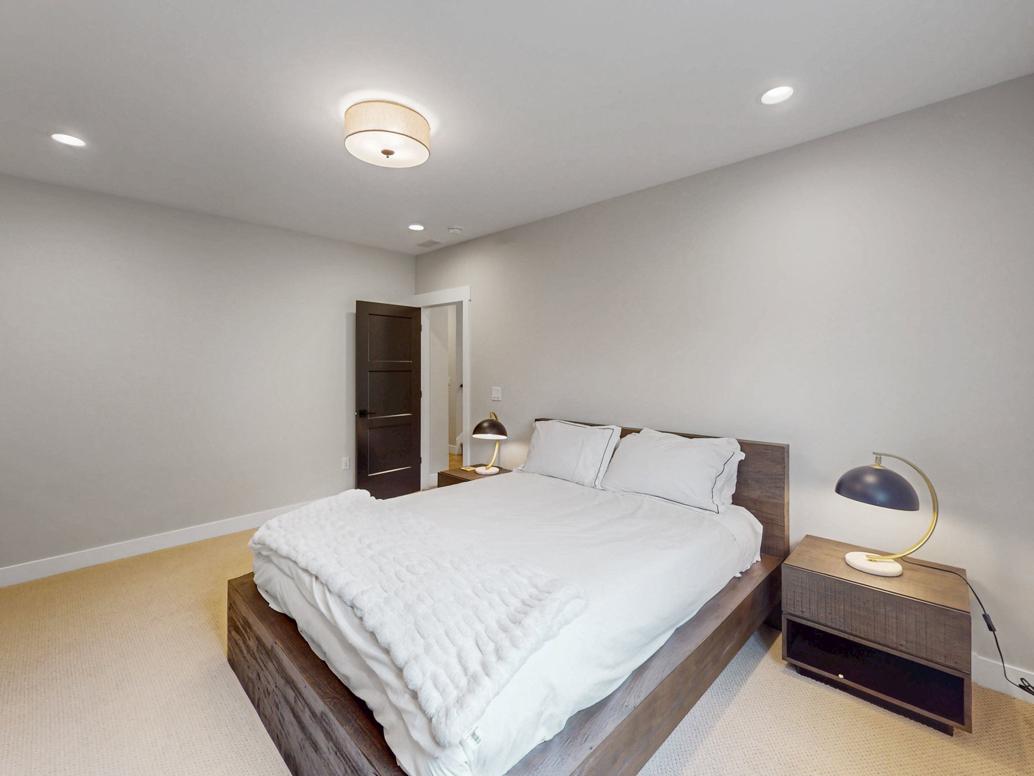Bedroom #4 with light-toned carpet flooring and neutral wall tones