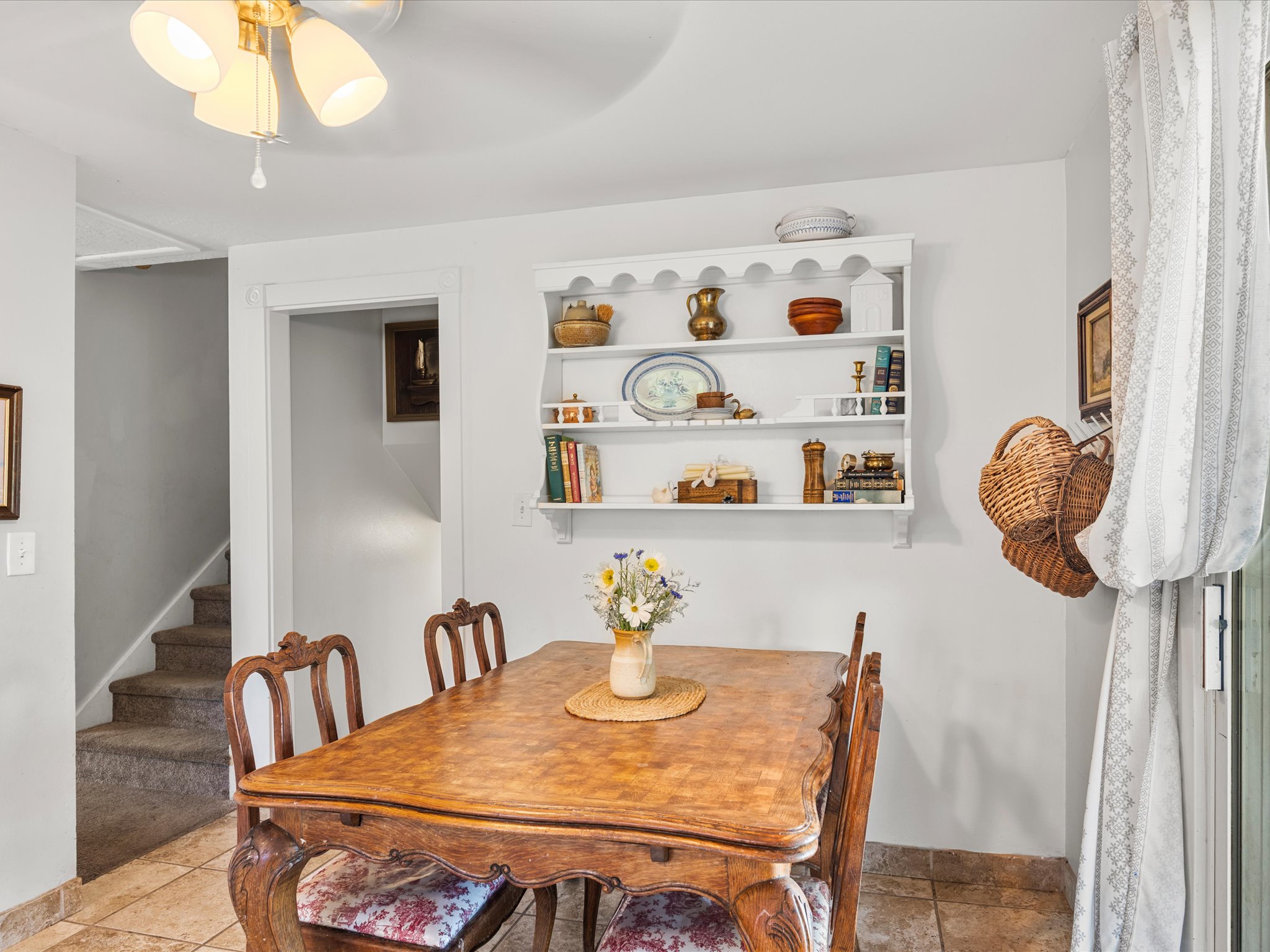 Dining area featuring tile flooring and a built-in wall shelf