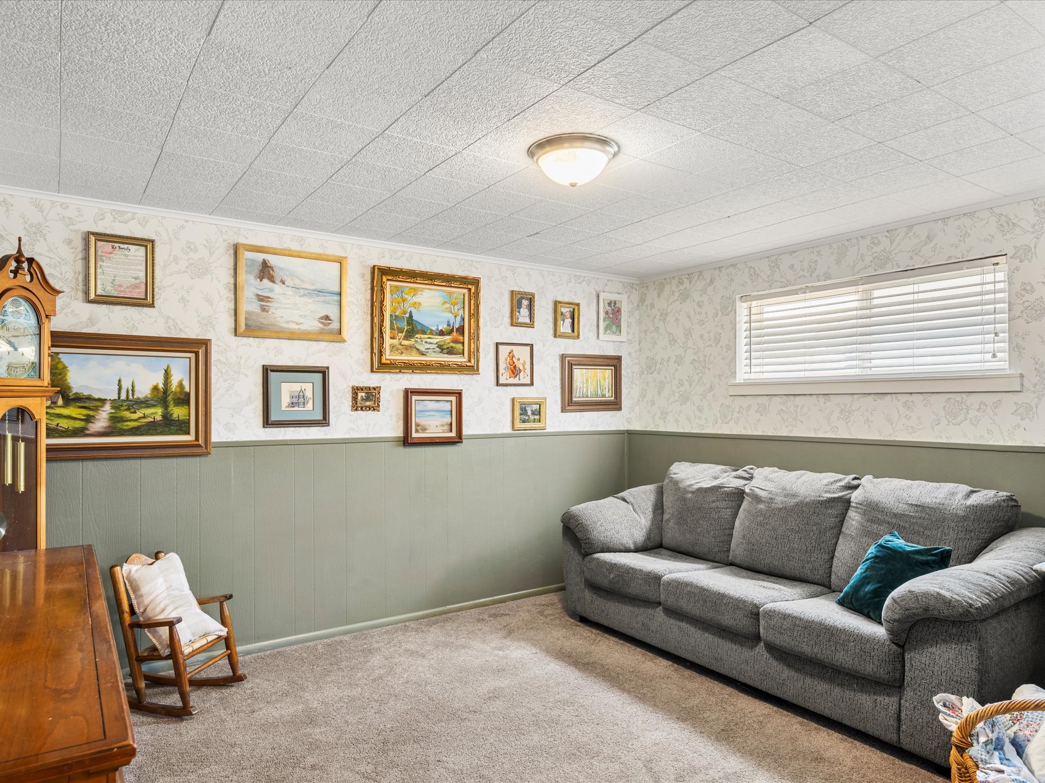 Carpeted room featuring recessed lighting, a window with horizontal blinds, and walls finished with wainscoting and patterned wallpaper