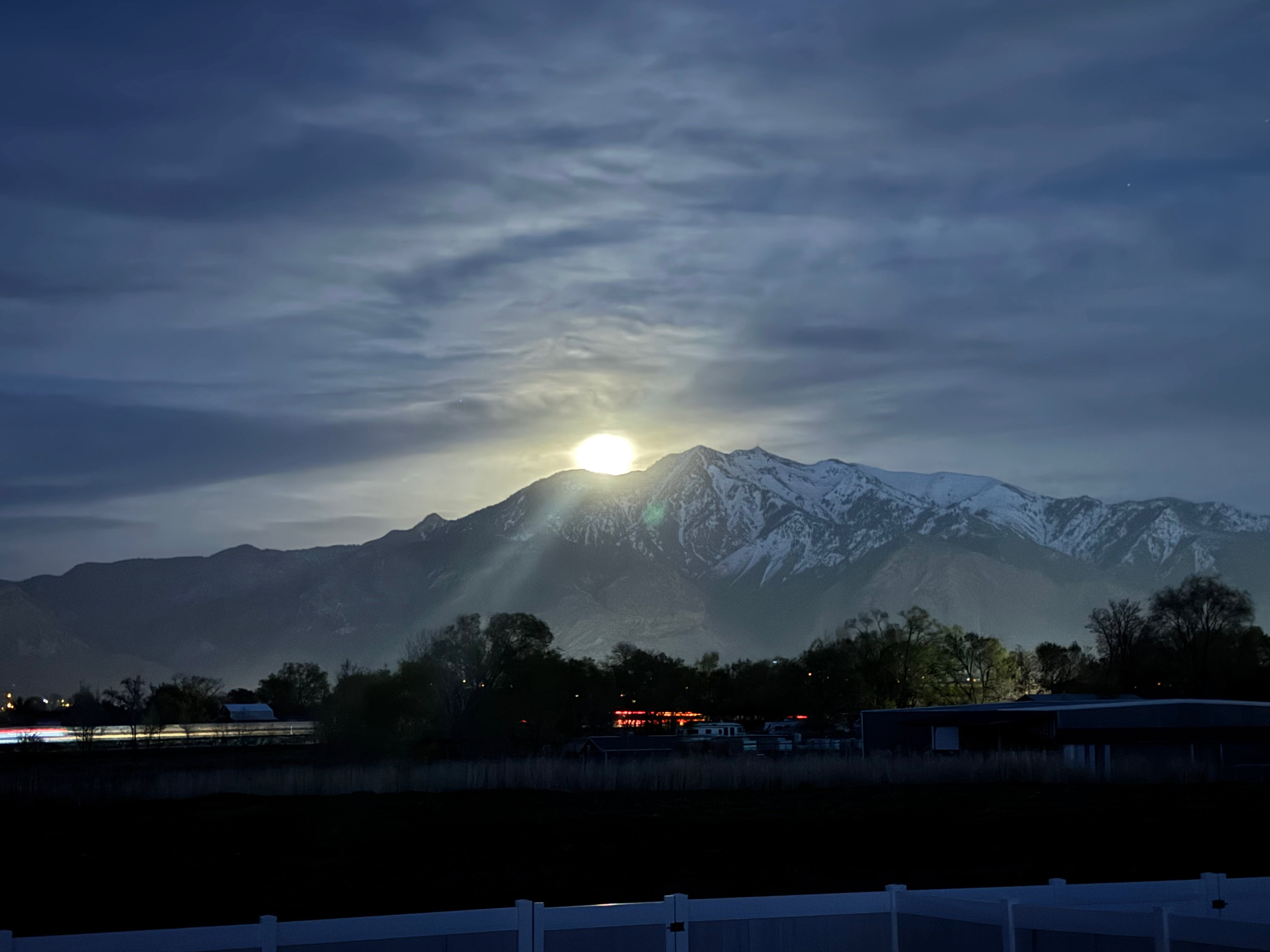 Snow-capped mountain range under a moonlit sky