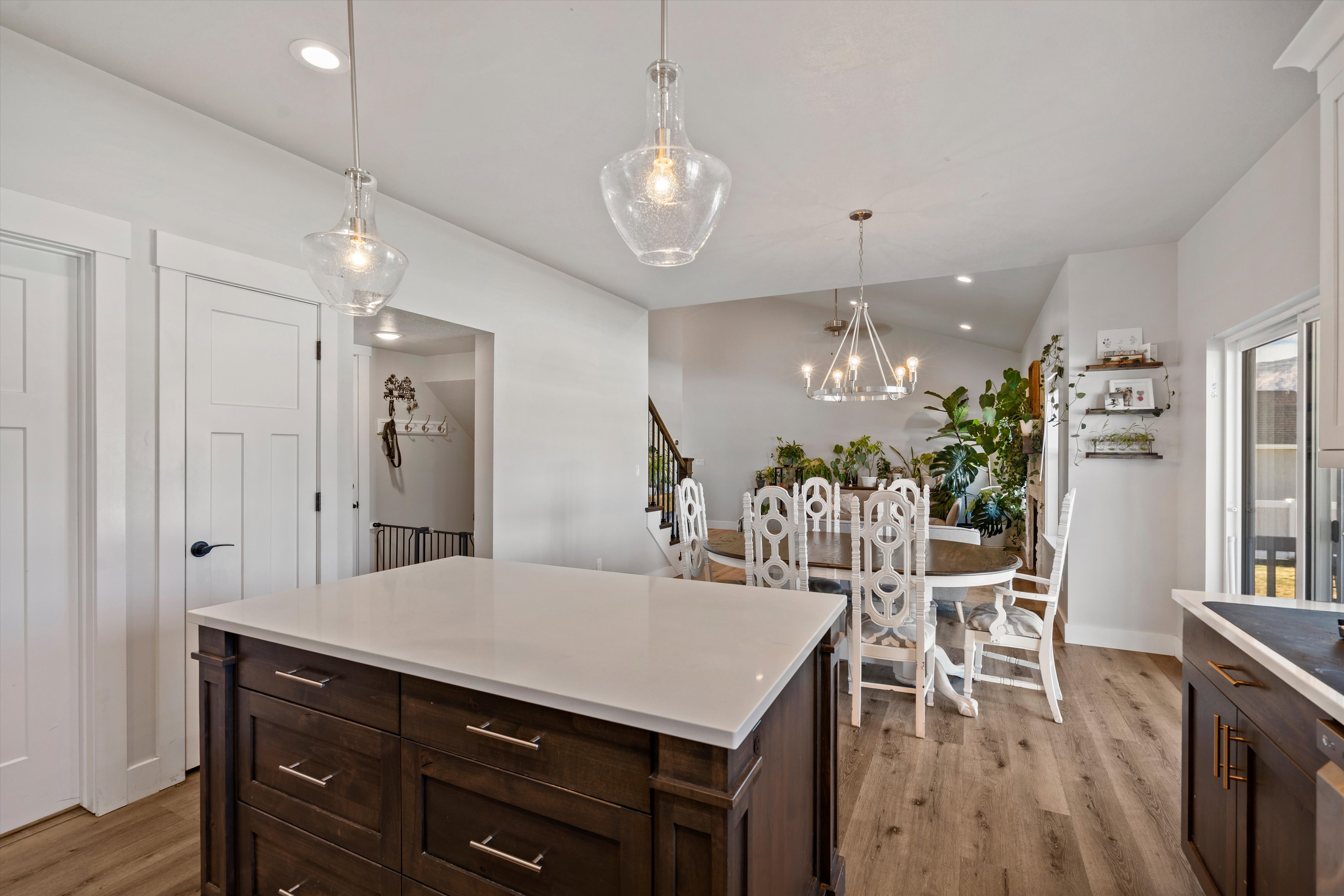 Kitchen island with a white countertop and dark wood cabinetry