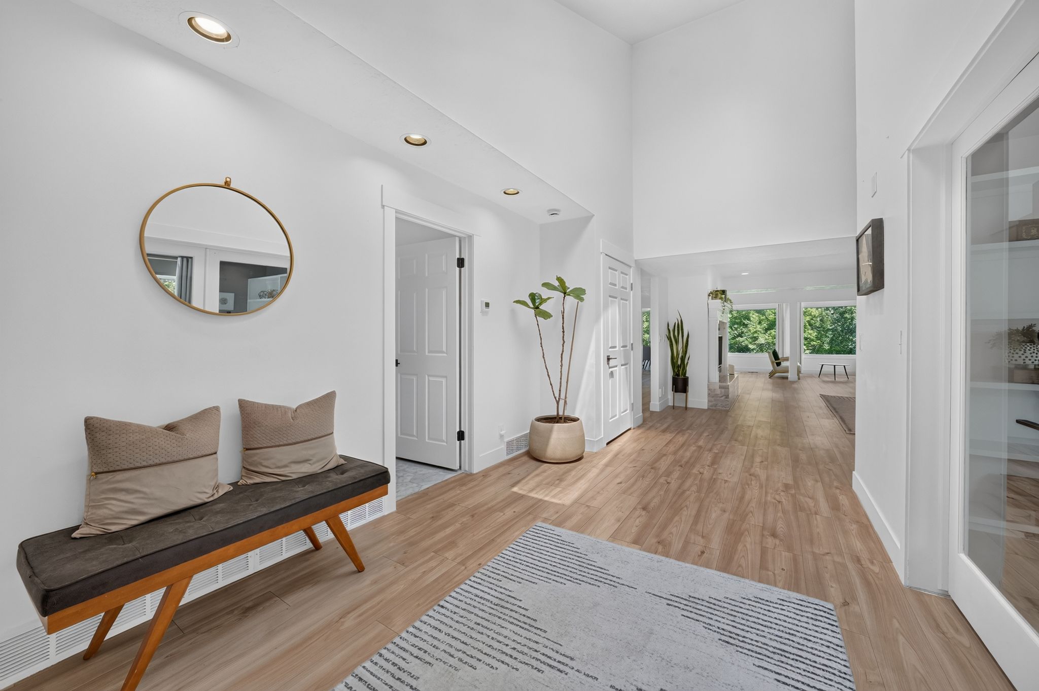 Entryway featuring vaulted ceilings, recessed lighting, wood-finish flooring, and crisp white walls