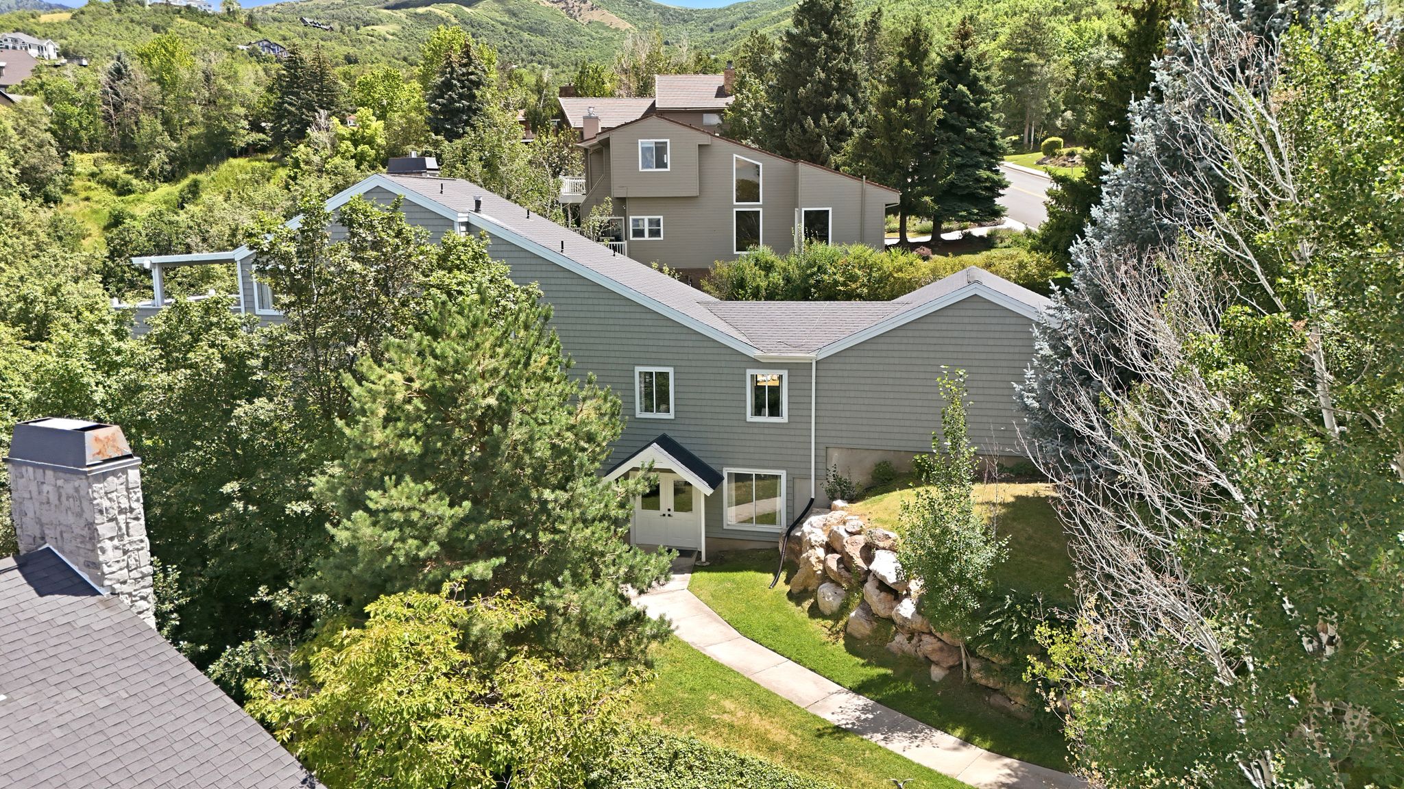 Multi-level residence featuring gray siding and white trim