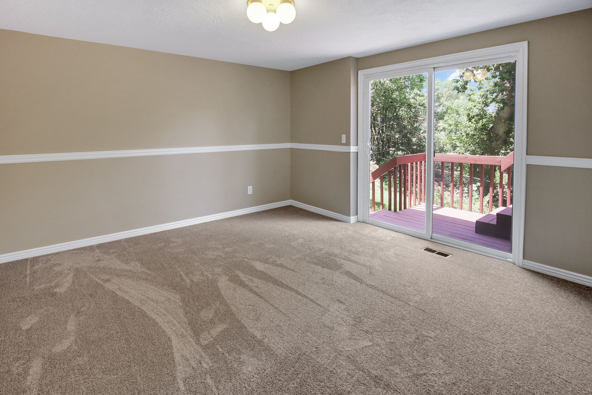 Expansive room for den/ office with sliding glass door to back deck