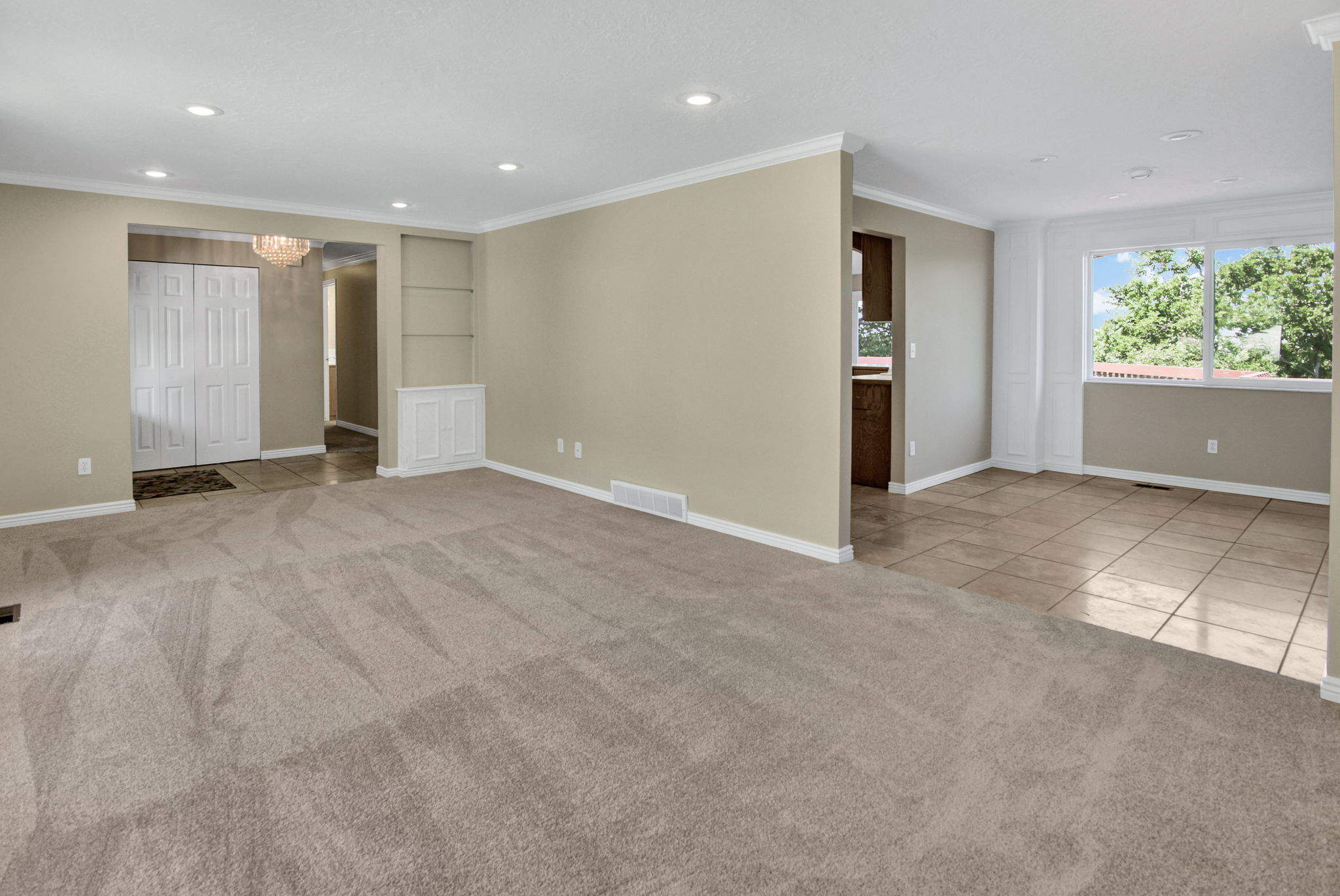 Second view to entry with double closet, built in shelf and view to formal dining