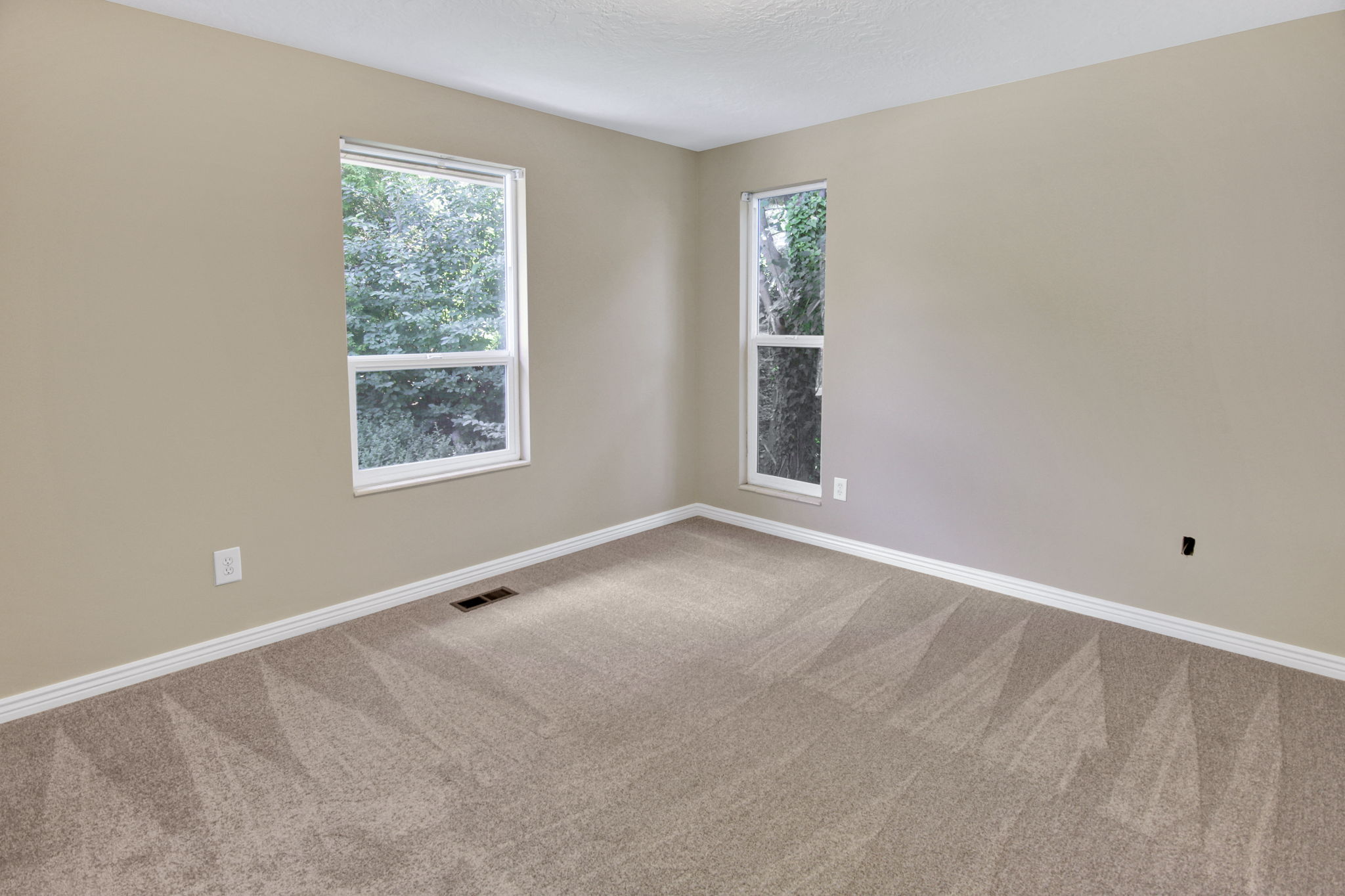 Bdrm 2 Neutral-toned walls complement the light tan carpeting